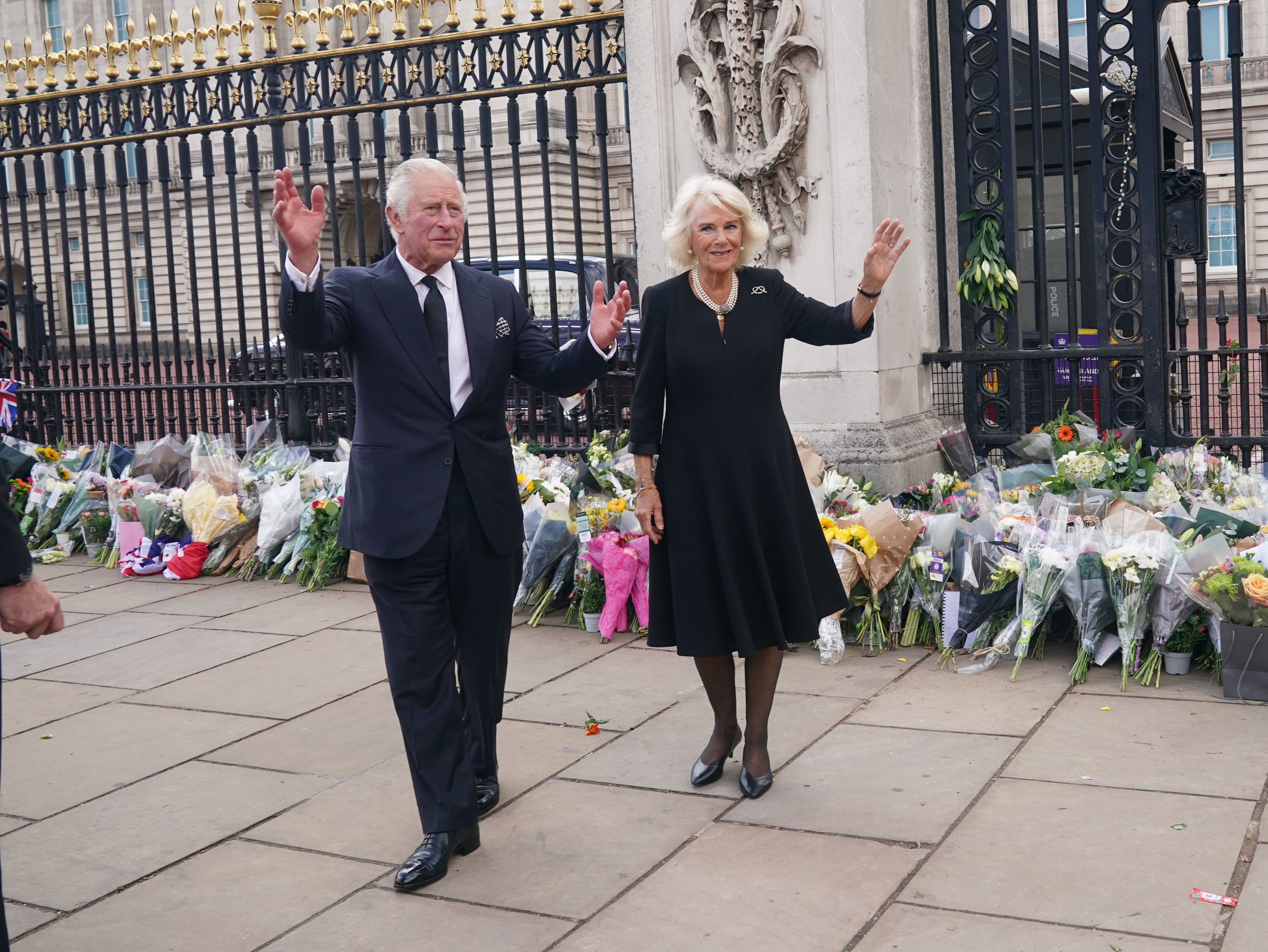 <p>King Charles III and wife Camilla, Queen Consort waved to mourners as they took in the tributes left for his mother, Queen Elizabeth II, outside Buckingham Palace in London on Sept. 9, 2022, the morning after <a href="https://www.wonderwall.com/celebrity/celebrities-dignitaries-react-to-death-of-queen-elizabeth-ii-647756.gallery">the monarch's death in Scotland</a>.</p>