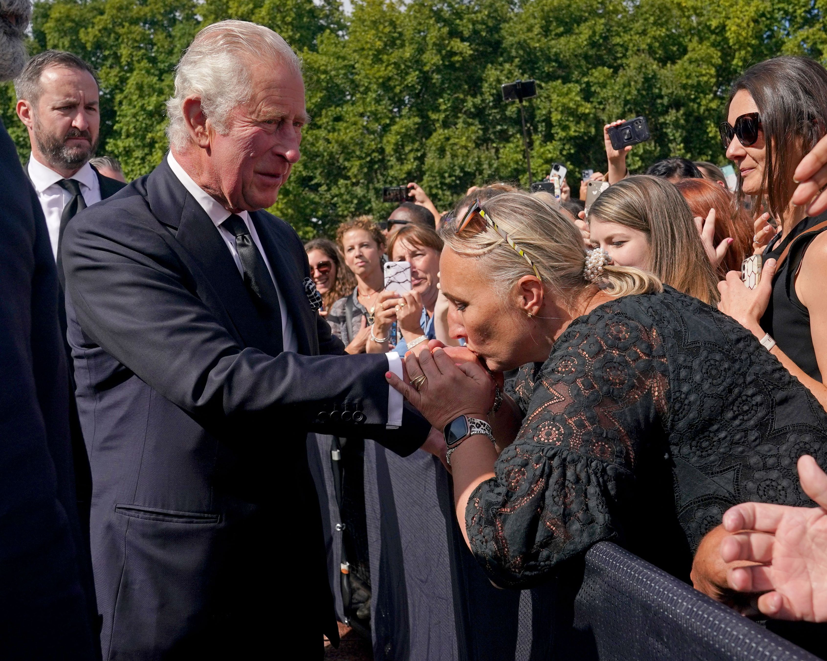 <p>A well-wisher kissed the hand of King Charles III on Sept. 9, 2022, during his walkabout outside Buckingham Palace in London to view the many messages and tributes left outside the gates following <a href="https://www.wonderwall.com/celebrity/celebrities-dignitaries-react-to-death-of-queen-elizabeth-ii-647756.gallery">the death of his mother</a>, Queen Elizabeth II, one day earlier. </p>