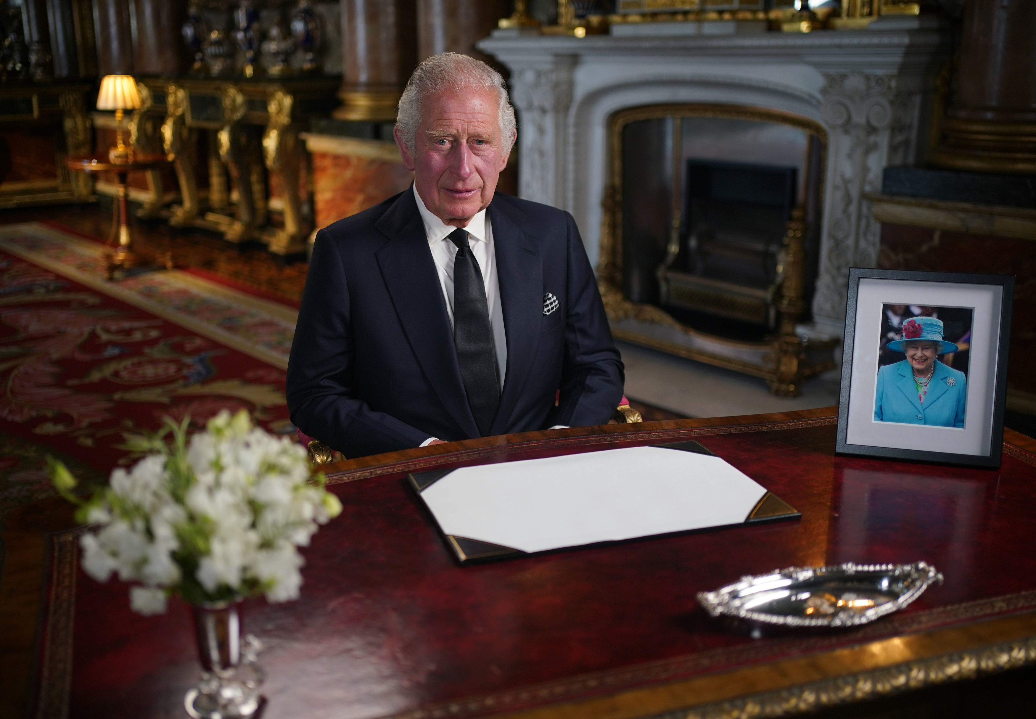 <p>King Charles III delivered his first address to the nation and the Commonwealth from the blue drawing room at Buckingham Palace in London on Sept. 9, 2022, one day after <a href="https://www.wonderwall.com/celebrity/celebrities-dignitaries-react-to-death-of-queen-elizabeth-ii-647756.gallery">the death of his mother</a>, Queen Elizabeth II. In his speech, he shared his "deep sense of gratitude for the more than 70 years" she served on the throne and paid tribute to her "life of service," pledging to "endeavour to serve you with loyalty, respect, and love" as she did for more than 70 years. He also spoke directly to his "darling Mama," saying, "Thank you. May flights of angels sing thee to thy rest." Charles also confirmed that his "darling wife" Camilla had become his Queen Consort, and announced that eldest son and heir <a href="https://www.wonderwall.com/celebrity/profiles/overview/prince-william-482.article">Prince William</a> <a href="https://www.wonderwall.com/celebrity/royals-line-british-throne-order-succession-3012158.gallery?photoId=648489">now holds Charles's previous titles including Duke of Cornwall and Prince of Wales</a>, making daughter-in-law Kate Middleton the new Princess of Wales -- the first woman to hold the title since his first wife, the late Princess Diana. Despite their fractured relationship, Charles also mentioned his younger son and his wife, telling his subjects, "I want also to express my love for Harry and Meghan as they continue to build their lives overseas."</p>