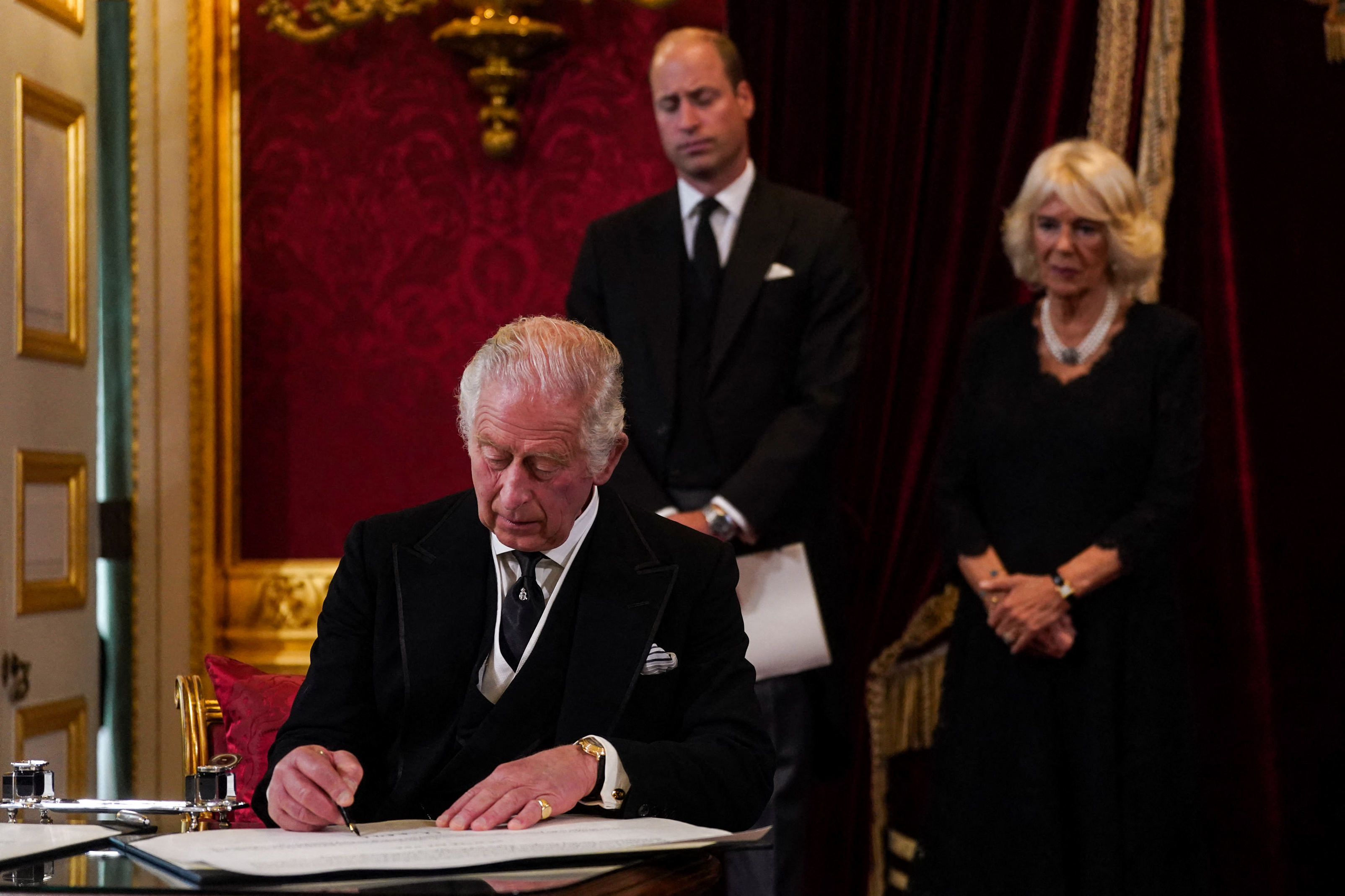 <p>A newly titled <a href="https://www.wonderwall.com/celebrity/profiles/overview/prince-william-482.article">Prince William</a>, who's now the Prince of Wales, and Camilla, Queen Consort watched as Britain's new King Charles III signed an oath to uphold the security of the Church in Scotland during a meeting of the Accession Council inside St. James's Palace in London on Sept. 10, 2022, to proclaim him as the new sovereign. He now signs his documents "Charles R," with the R standing for Rex, which means king in Latin.</p>