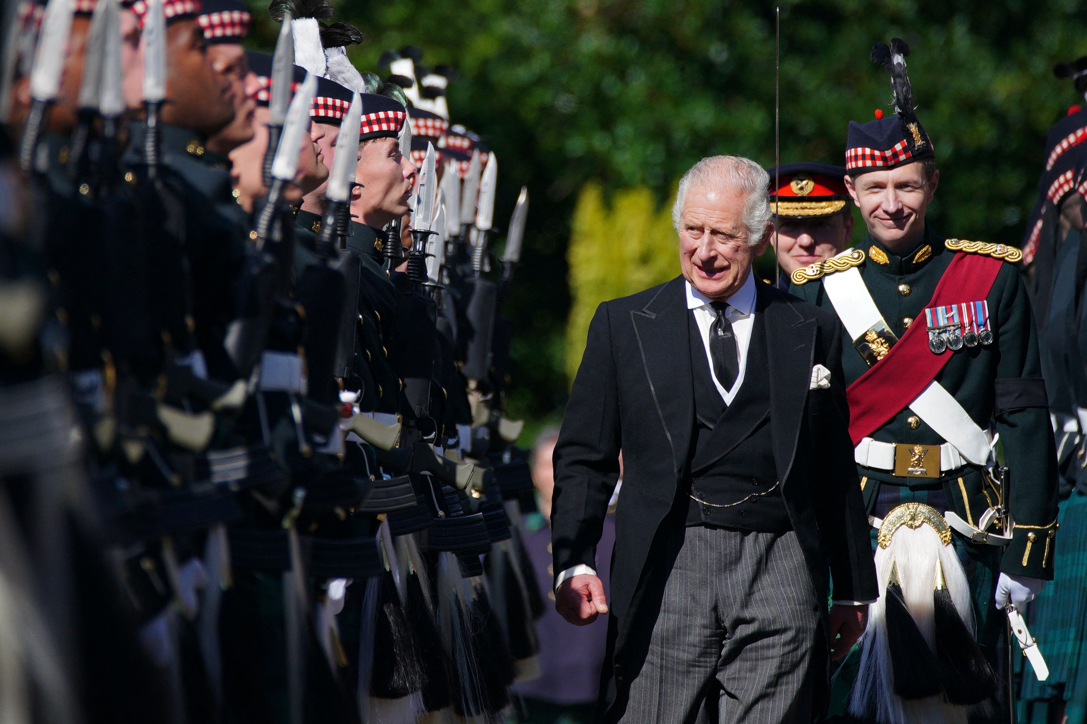 <p>Britain's King Charles III inspected an Honour Guard as he arrived at the Palace of Holyroodhouse in Edinburgh, Scotland, on Sept. 12, 2022, before following his mother Queen Elizabeth II's coffin from there to St. Giles Cathedral.</p>