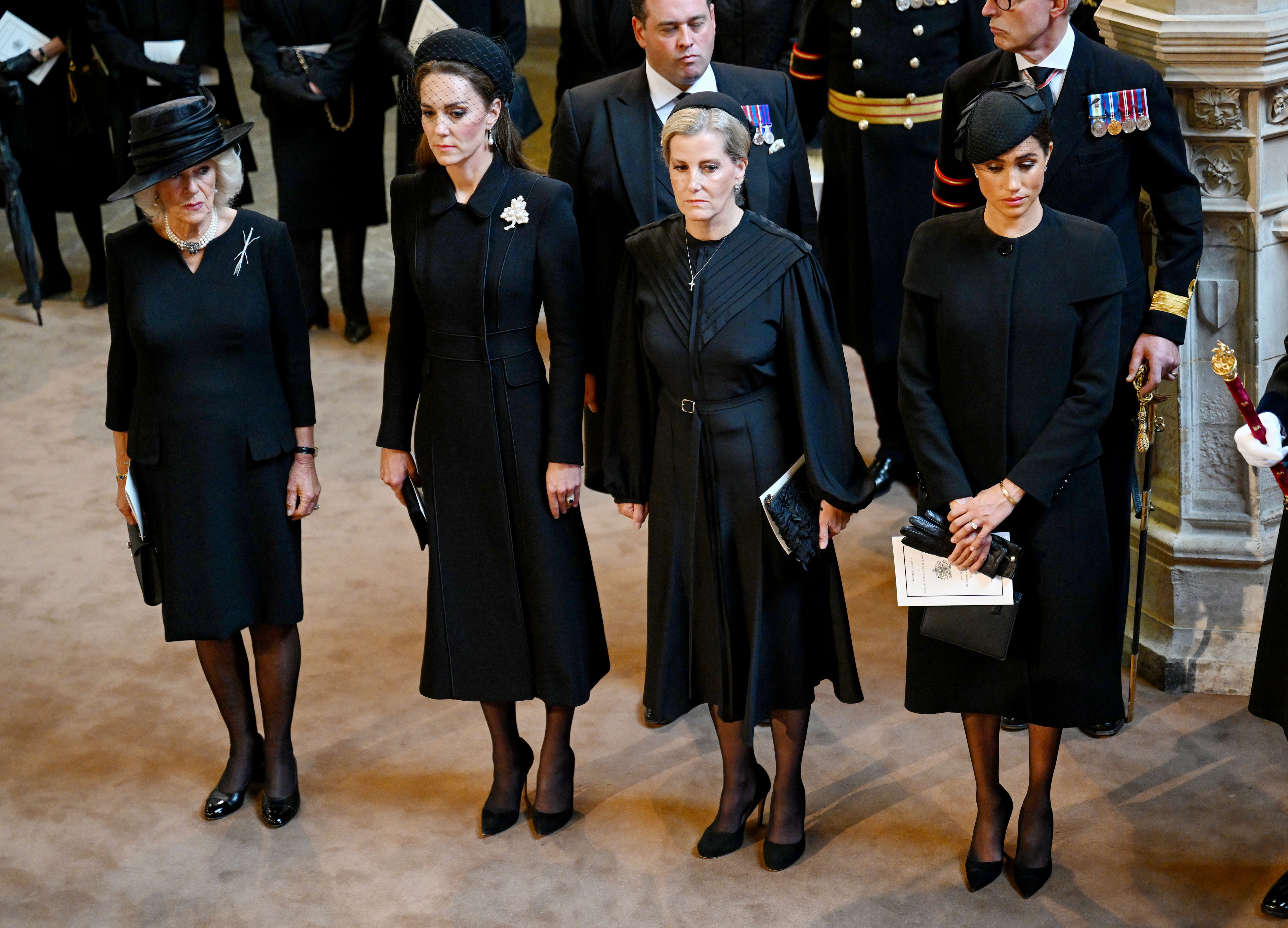 <p>On Sept. 14, 2022, Camilla, Queen Consort, Princess Kate, Sophie, Countess of Wessex and Duchess Meghan stood together and paid their respects as Queen Elizabeth II's coffin was carried into Westminster Hall, where it will lie in state until her funeral, following a procession from Buckingham Palace through the streets of London.</p>