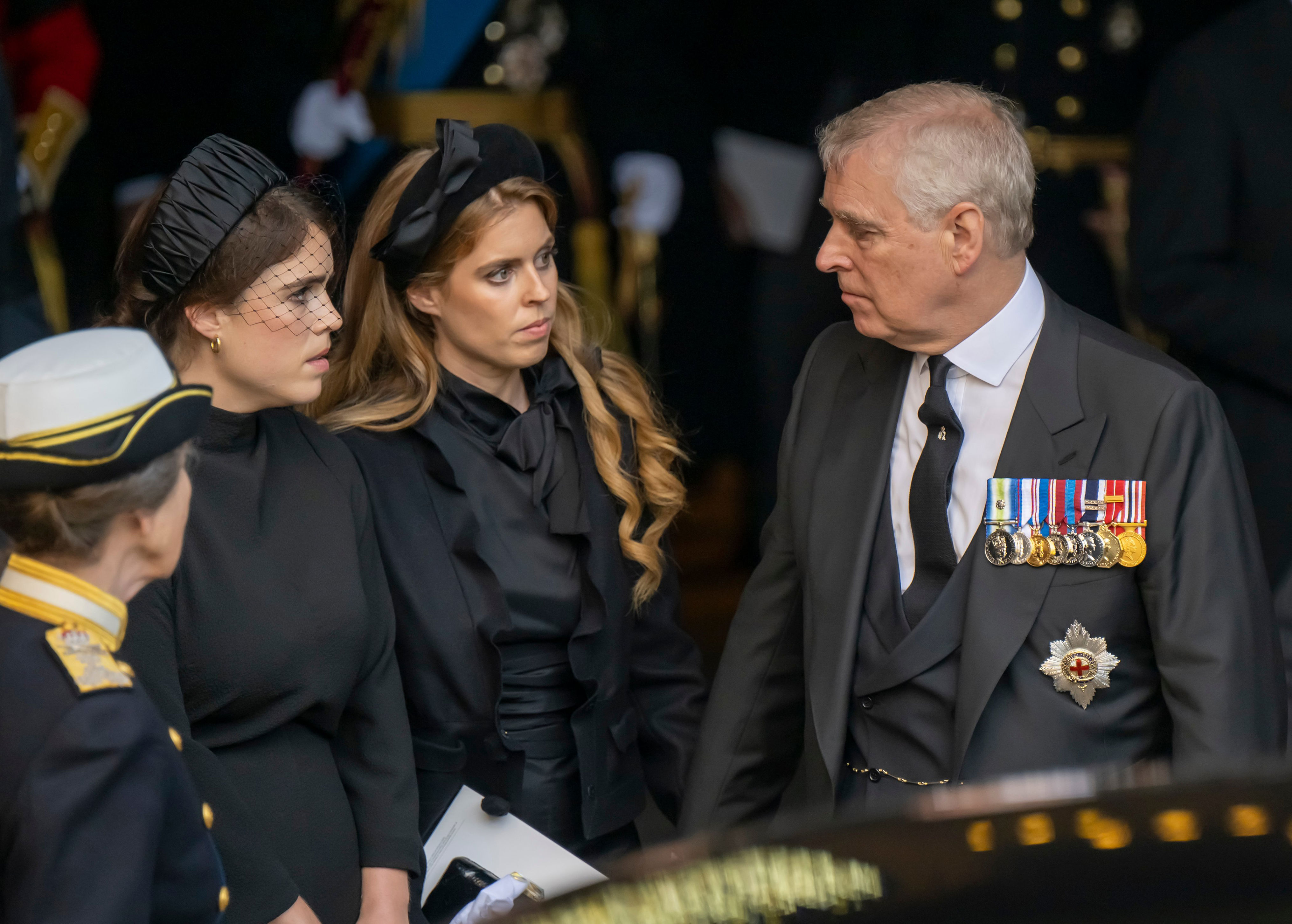 <p>Princess Eugenie and Princess Beatrice spoke to their father, Prince Andrew, at the Palace of Westminster in London on Sept. 14, 2022, after Queen Elizabeth II's coffin arrived from Buckingham Palace to begin her lying-in-state five days ahead of her funeral.</p>