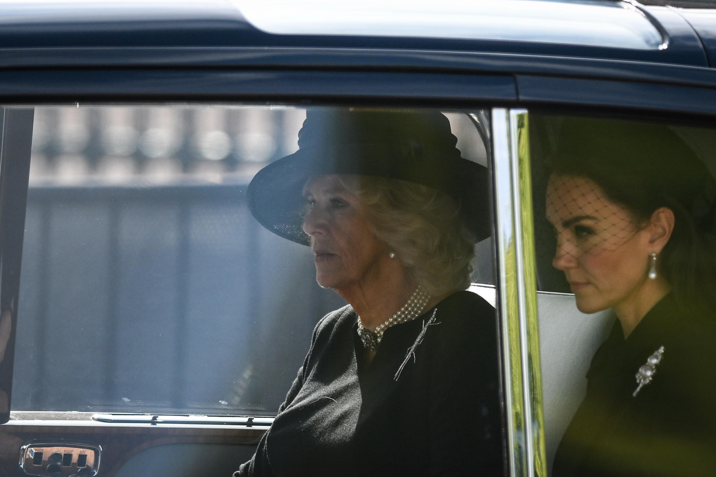 <p>Camilla, Queen Consort and Princess Kate departed Buckingham Palace in a car together to follow the coffin of Queen Elizabeth II, adorned with a royal standard and the Imperial State Crown, as it was pulled by a gun carriage of the King's Troop Royal Horse Artillery during a procession to Westminster Hall on Sept. 14, 2022, for the late monarch's lying in state.</p>