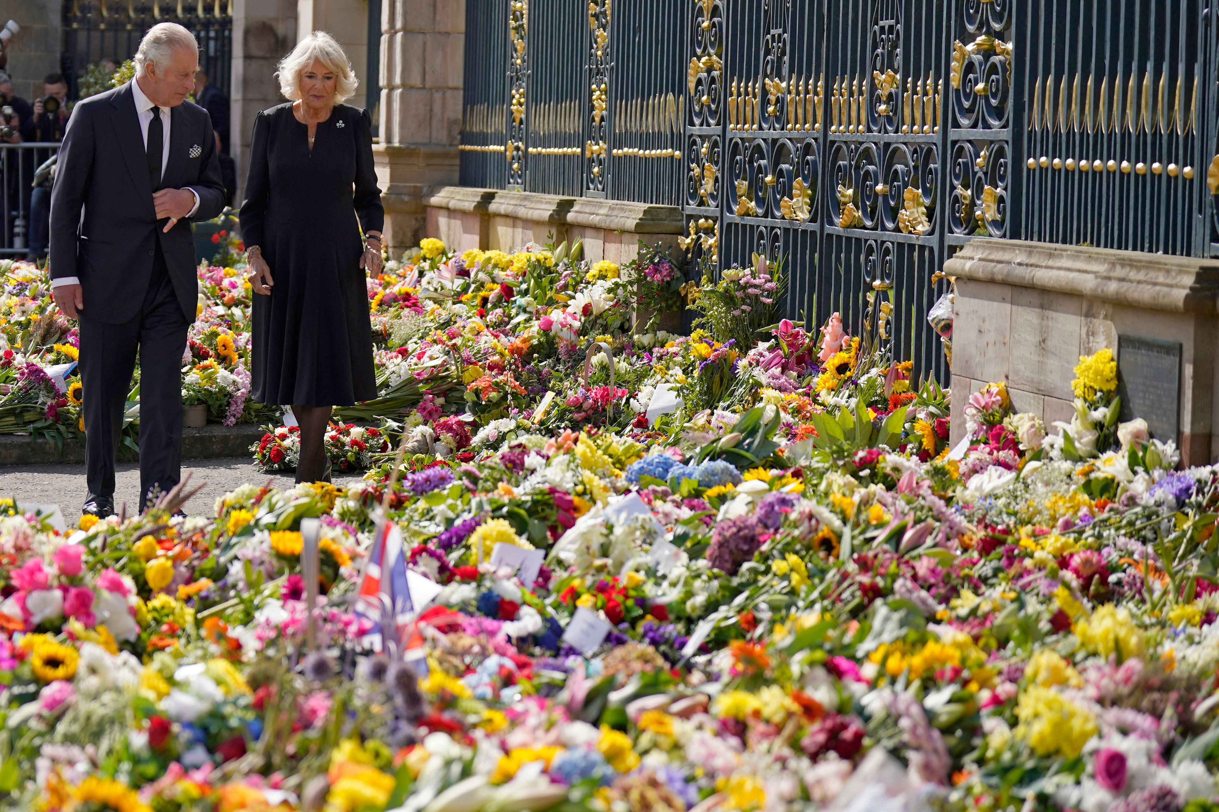 <p>Britain's King Charles III and Camilla, Queen Consort view floral tributes left outside Hillsborough Castle in Belfast, Northern Ireland, on Sept. 13, 2022, during his visit to the U.K. nation in the wake of his mother Queen Elizabeth II's <a href="https://www.wonderwall.com/celebrity/celebrities-dignitaries-react-to-death-of-queen-elizabeth-ii-647756.gallery">death five days earlier</a>.</p>