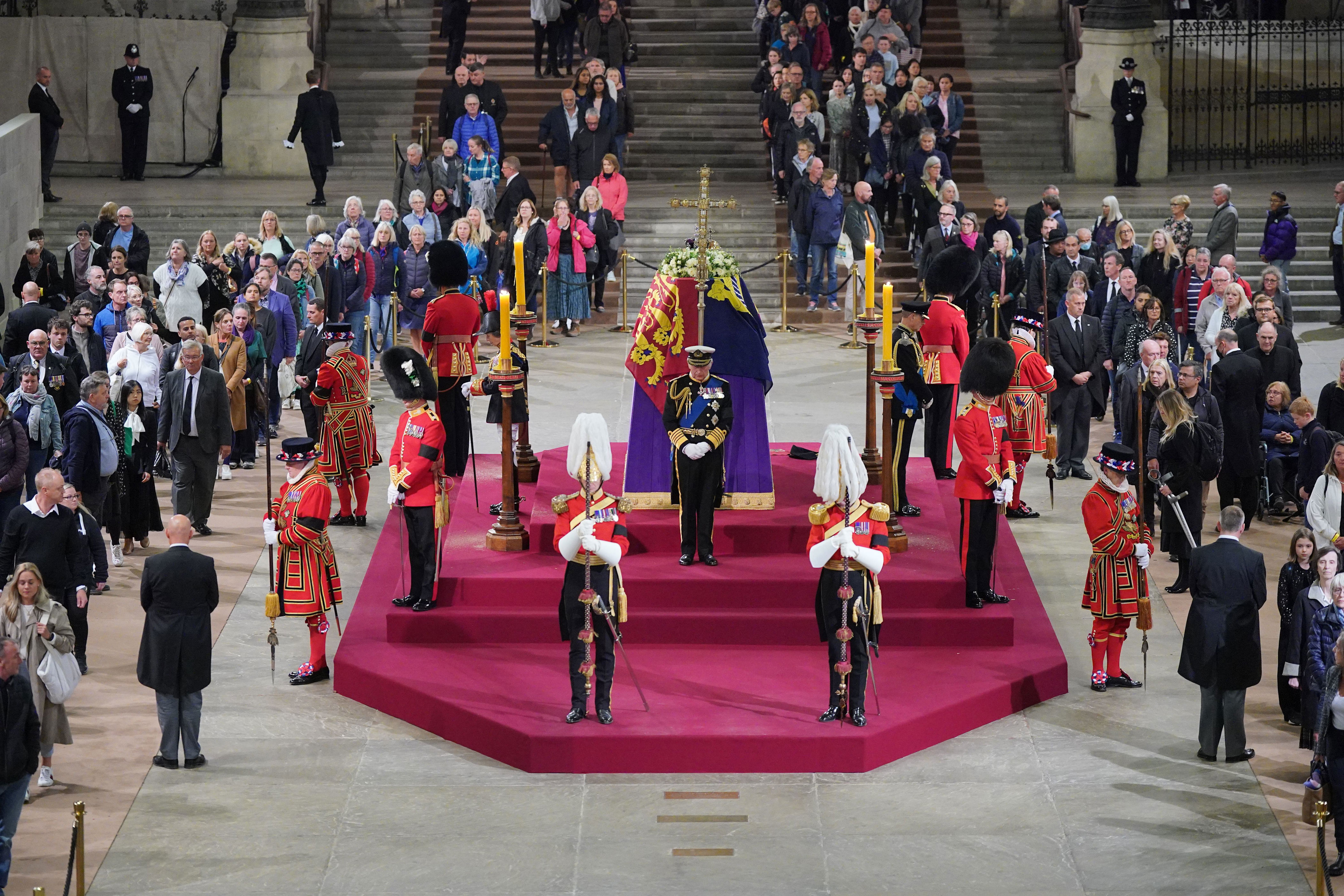 <p>Members of the public filed past as King Charles III (front), Princess Anne (left), Prince Andrew (not pictured) and Prince Edward (right) held a 15-minute vigil beside the coffin of their mother, Queen Elizabeth II, during her lying-in-state on the catafalque in Westminster Hall at the Palace of Westminster in London on Sept. 16, 2022, ahead of her funeral three days later.</p>