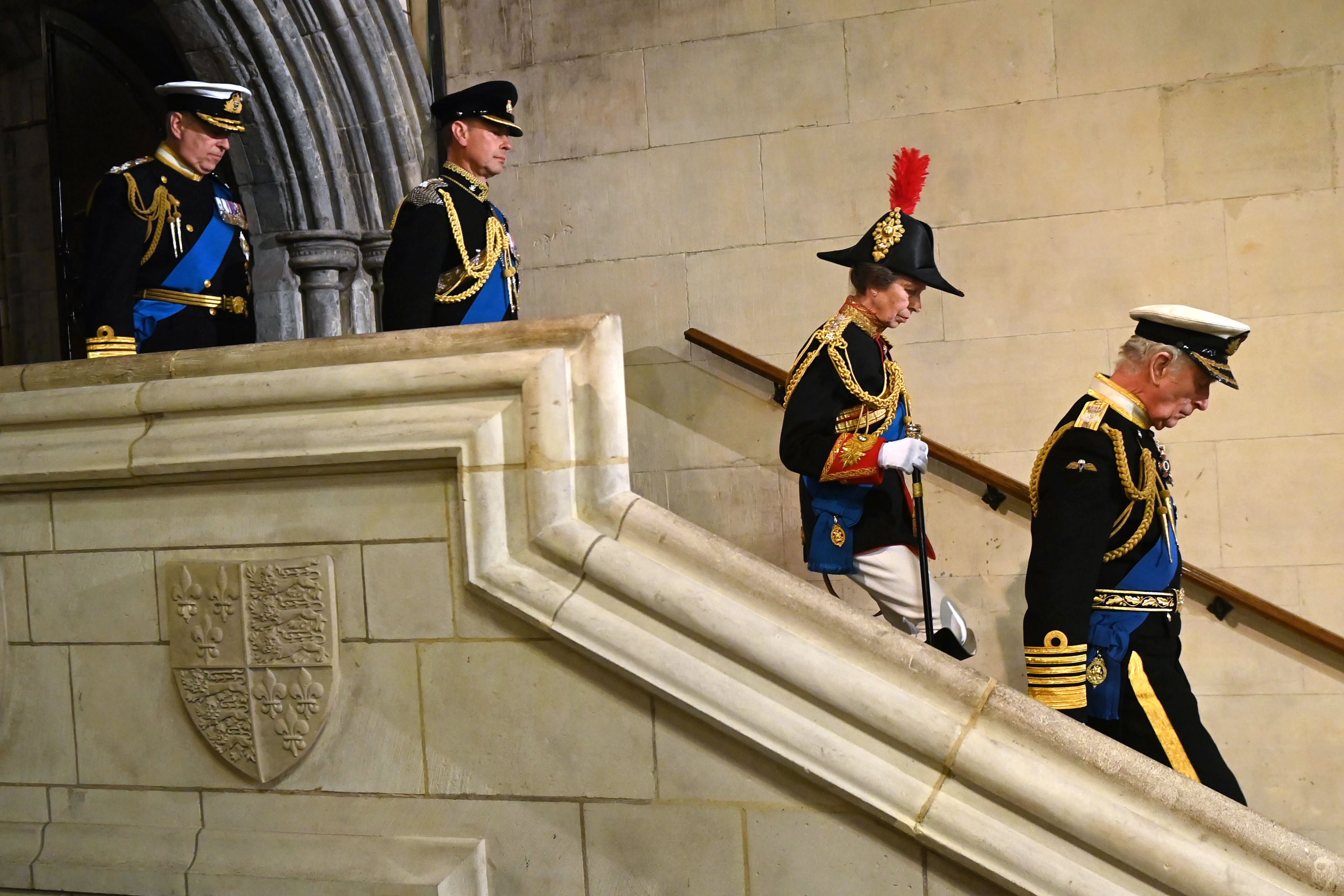 <p>King Charles III, Princess Anne, Prince Edward and Prince Andrew made their way down a staircase at Westminster Hall at the Palace of Westminster in London on Sept. 16, 2022, and walked to the catafalque upon which the coffin of their mother, Queen Elizabeth II, rested. They surrounded her body and held vigil for 15 minutes as crowds of mourners filed past during the late monarch's lying-in-state ahead of her Sept. 19 funeral.</p>