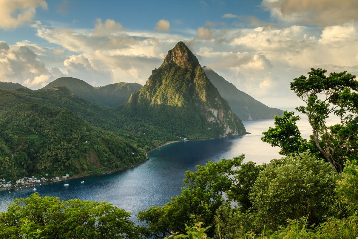 <p>St. Lucia looks like a scene set in Jurassic Park. The serene tapering mountains are the Pitons, located on the western side of the island. Other wonders you’ll find are volcanic beaches, fishing villages and diving spots.</p><p>Where to stay: <a href="https://www.jademountain.com/">Jade Mountain</a> is a majestic escape that might just seem like a dream. This hotel was built into the side of a cliff along the ocean. Without a fourth wall in the rooms, guests can stargaze from their bed at nighttime, and breathe the ocean air. It’s designed around its surroundings from bringing in local farming to indigenous herbal medicine and cacao harvesting.</p>