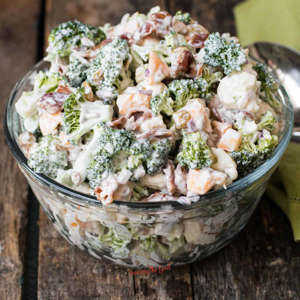 This easy recipe for Amish broccoli salad combines chopped broccoli, chopped cauliflower, diced red onion, sunflower seeds, and raisins combined with a creamy dressing all topped with crispy bacon bits. As summer salad season approaches, a traditional Amish broccoli cauliflower salad recipe is a great way to enjoy chopped fresh broccoli florets and cauliflower florets...Read More