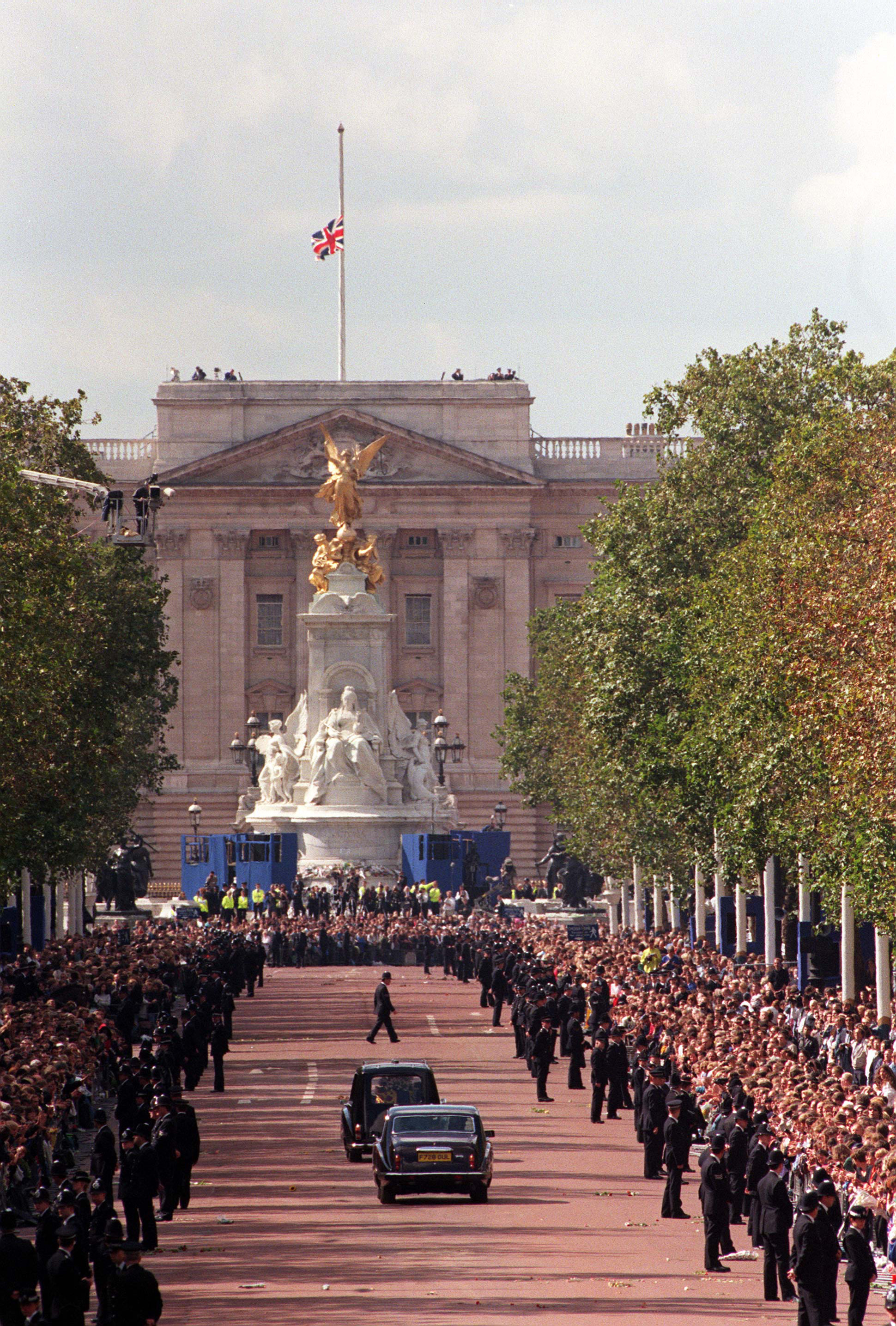 <p>Police kept enormous crowds of mourners back from the road as the hearse carrying the coffin of Diana, Princess of Wales drove down The Mall toward Buckingham Palace in London following her funeral service at Westminster Abbey on Sept. 6, 1997, on its way to her family estate, Althorp, where she was privately buried on a small island.</p>