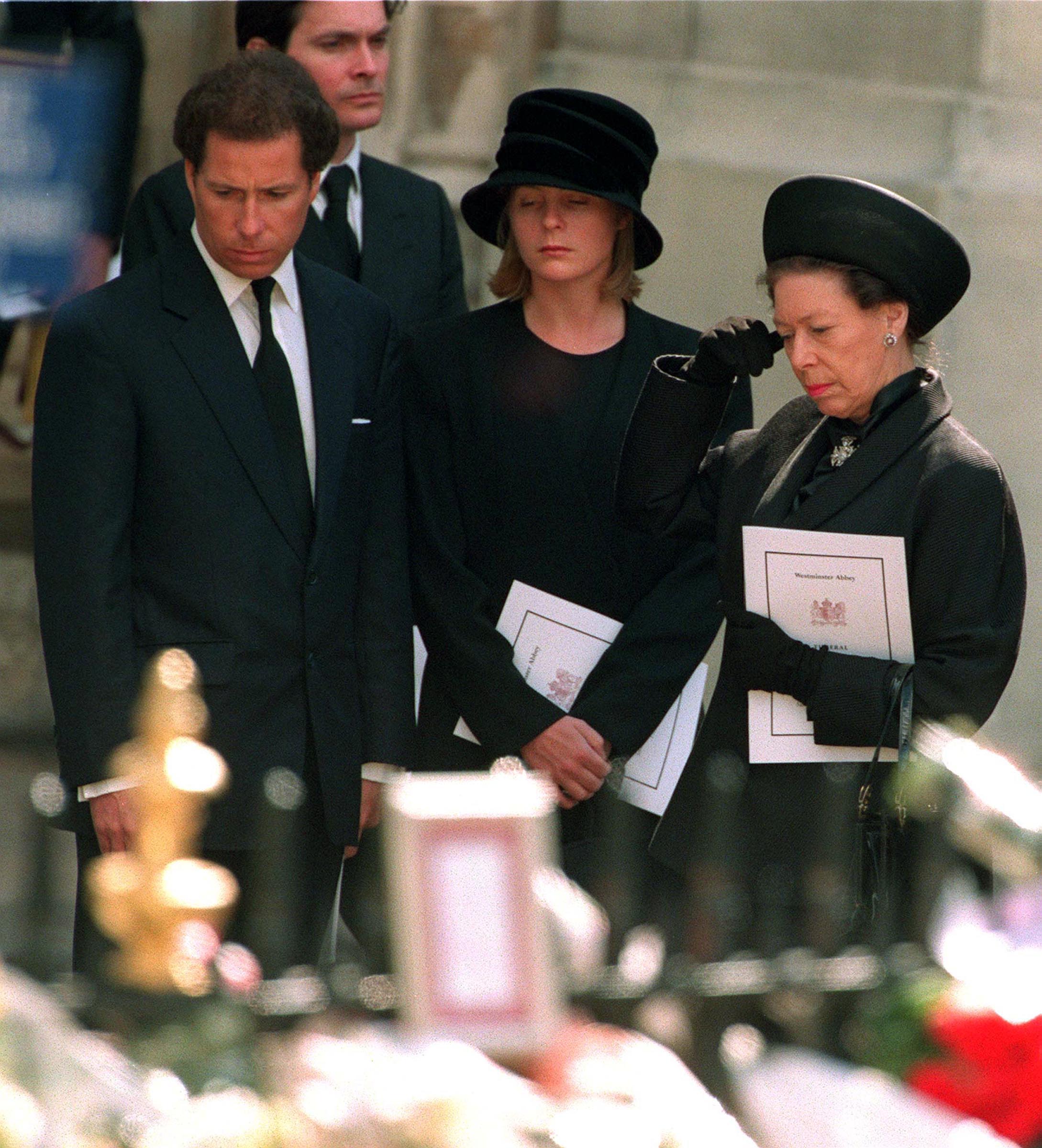 <p>Princess Margaret, son Viscount Linley (who's now the Earl of Snowdon) and his then-wife, Lady Serena Linley, paused to look at tributes left by the public as they left Westminster Abbey in London after the funeral service for Princess Diana on Sept. 6, 1997. </p>