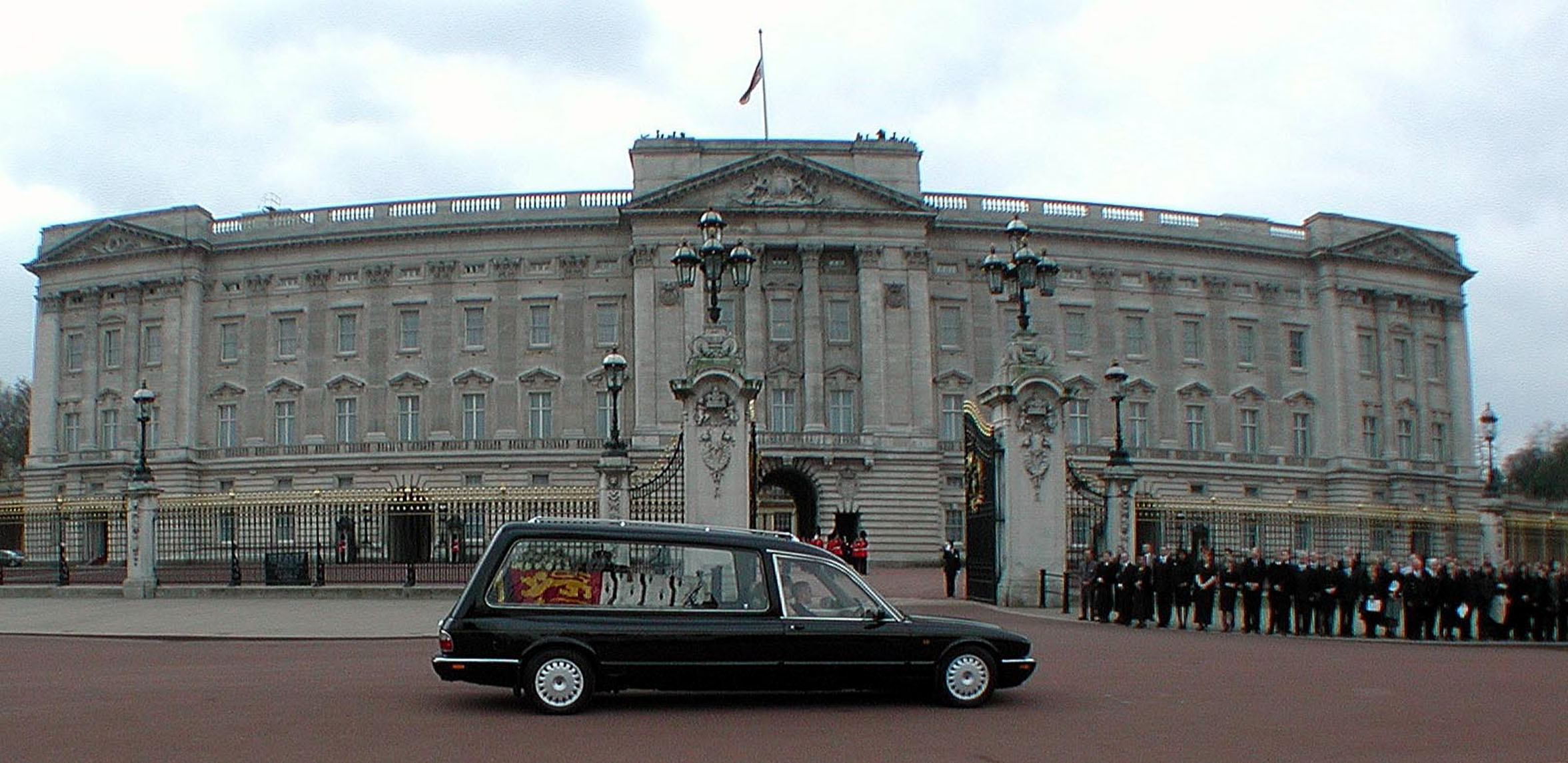 <p>The hearse carrying the coffin of Queen Elizabeth the Queen Mother is seen passing Buckingham Palace on the day of her funeral, April 9, 2002. </p>