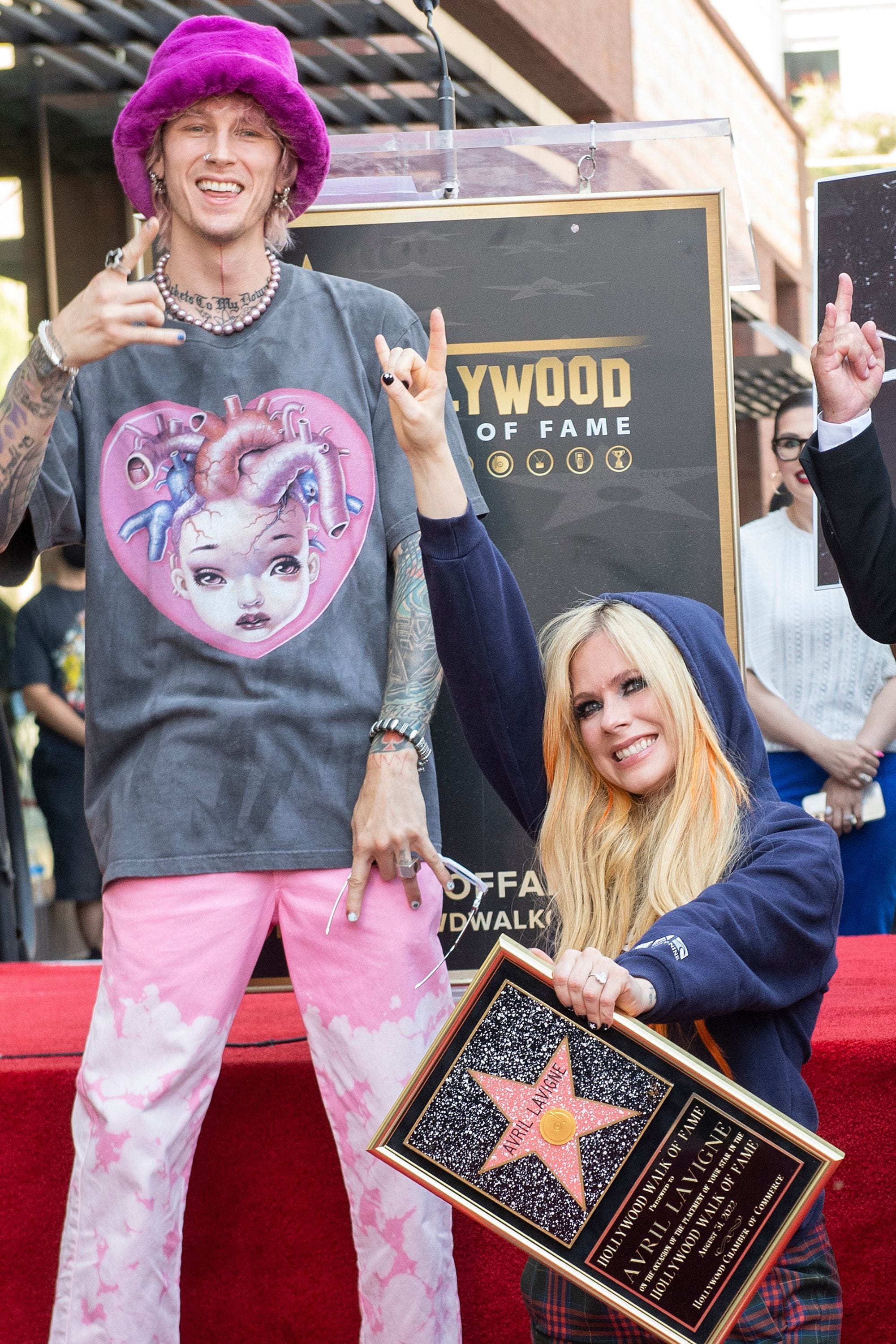 Rapper <a href="https://www.usatoday.com/story/entertainment/celebrities/2022/06/27/machine-gun-kelly-discusses-mental-health-suicide-attempt-hulu-doc/7750579001/">Machine Gun Kelly</a>, left, was there to support Lavigne and pose for photos. The two recently collaborated on the song "Bois Lie" from Lavigne's album <a href="https://www.usatoday.com/story/entertainment/music/2022/02/24/avril-lavigne-interview-machine-gun-kelly-travis-barker-love-sux-album/6832716001/">"Love Sux."</a><br> <br> "I can remember seeing these legendary names, and I never could have imagined mine would be here," said Lavigne during the ceremony. "This is so crazy. I am so grateful. This is probably one of the coolest days of my life."