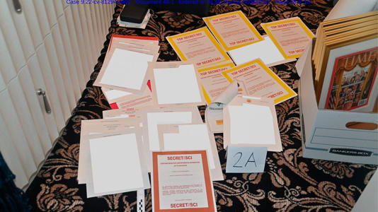 This image contained in a DOJ court filing on Aug. 30, 2022, and redacted in part by the FBI, shows a photo of documents seized during the Aug. 8, 2022, search by the FBI of former President Trump's Mar-a-Lago estate in Florida. AP Newsroom
