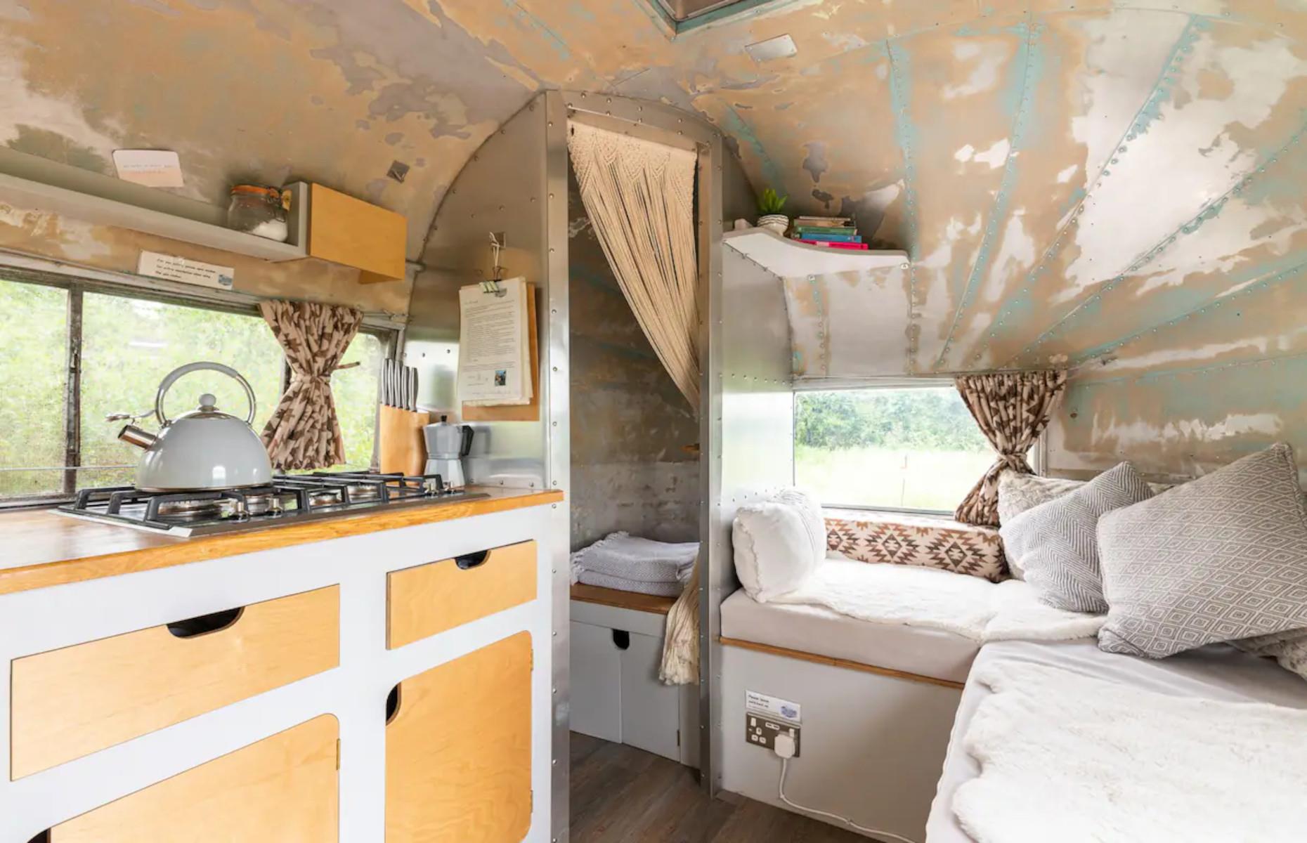 <p>Tucked away in a leafy grotto with its own private meadow in Hereford in the UK, this beautifully restored 1956 Airstream boasts an unusual shabby-chic interior. The rustic exposed roof and vintage yellow cabinetry add a quirky feel to this unique <a href="https://www.airbnb.co.uk/rooms/49959548">Airbnb</a> space.</p>
