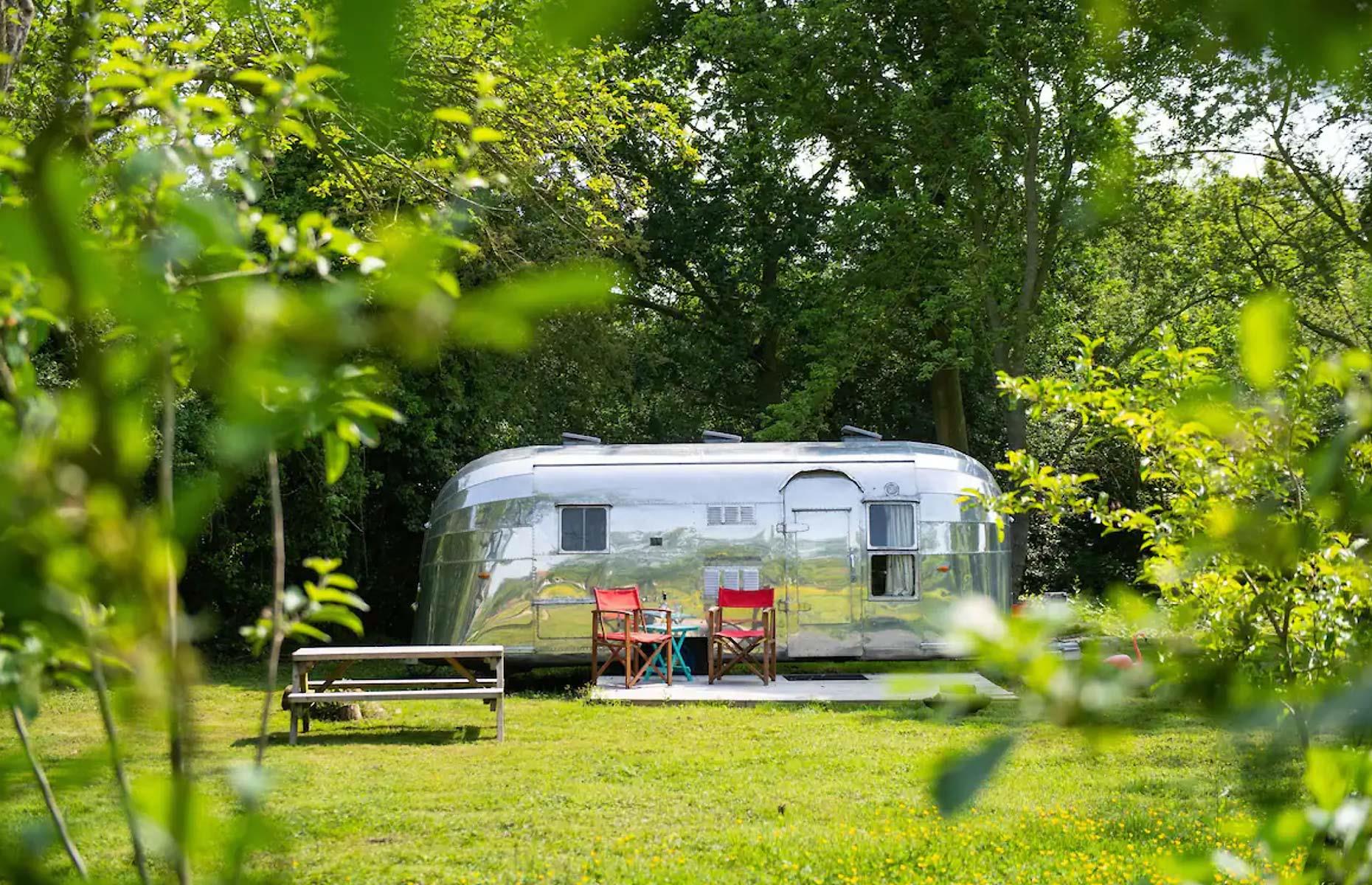 <p>This funky retro Airstream in Mundham, England is available to <a href="https://www.airbnb.co.uk/rooms/18261133">rent on Airbnb</a>. The 1957 Caravanner is parked in a quiet clearing in picturesque woodlands, and is fully kitted out to accommodate a comfortable stay for a couple or young family. </p>