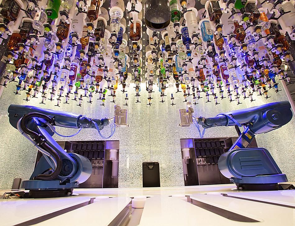 <p>On Royal Caribbean’s Oasis of the Seas, guests can get drinks specially made from two robotic bartenders at Bionic Bar. With the ceiling above the bar lined with upside bottles hanging, watching the process of giant mechanical arms pouring and shaking your cocktail is just as good as how it tastes.</p>