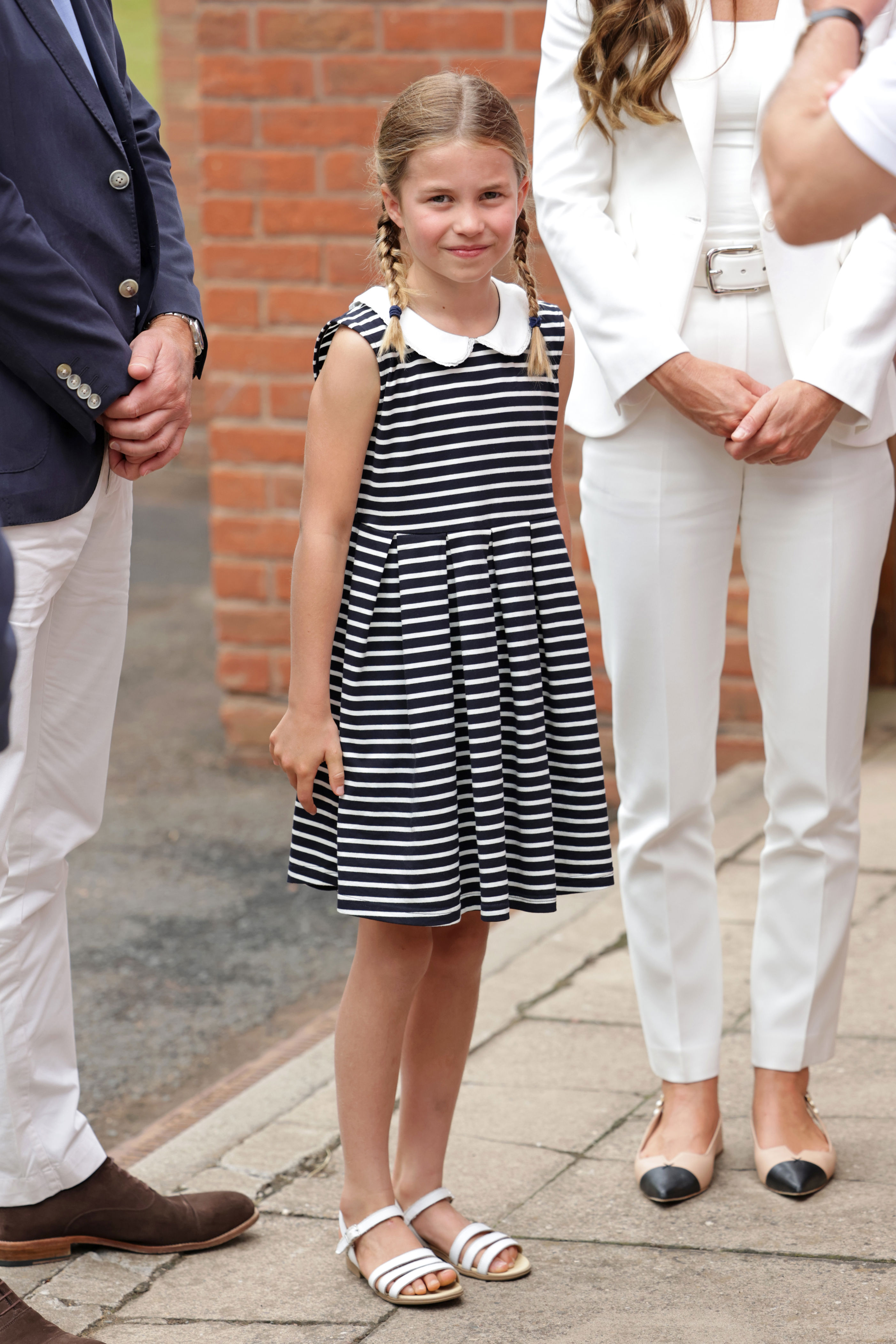 <p>Princess Charlotte wore white sandals and a striped summer dress with a Peter Pan collar as she joined her parents for a visit to the SportsAid House at the 2022 Commonwealth Games in Birmingham, England, on Aug. 2, 2022.</p>