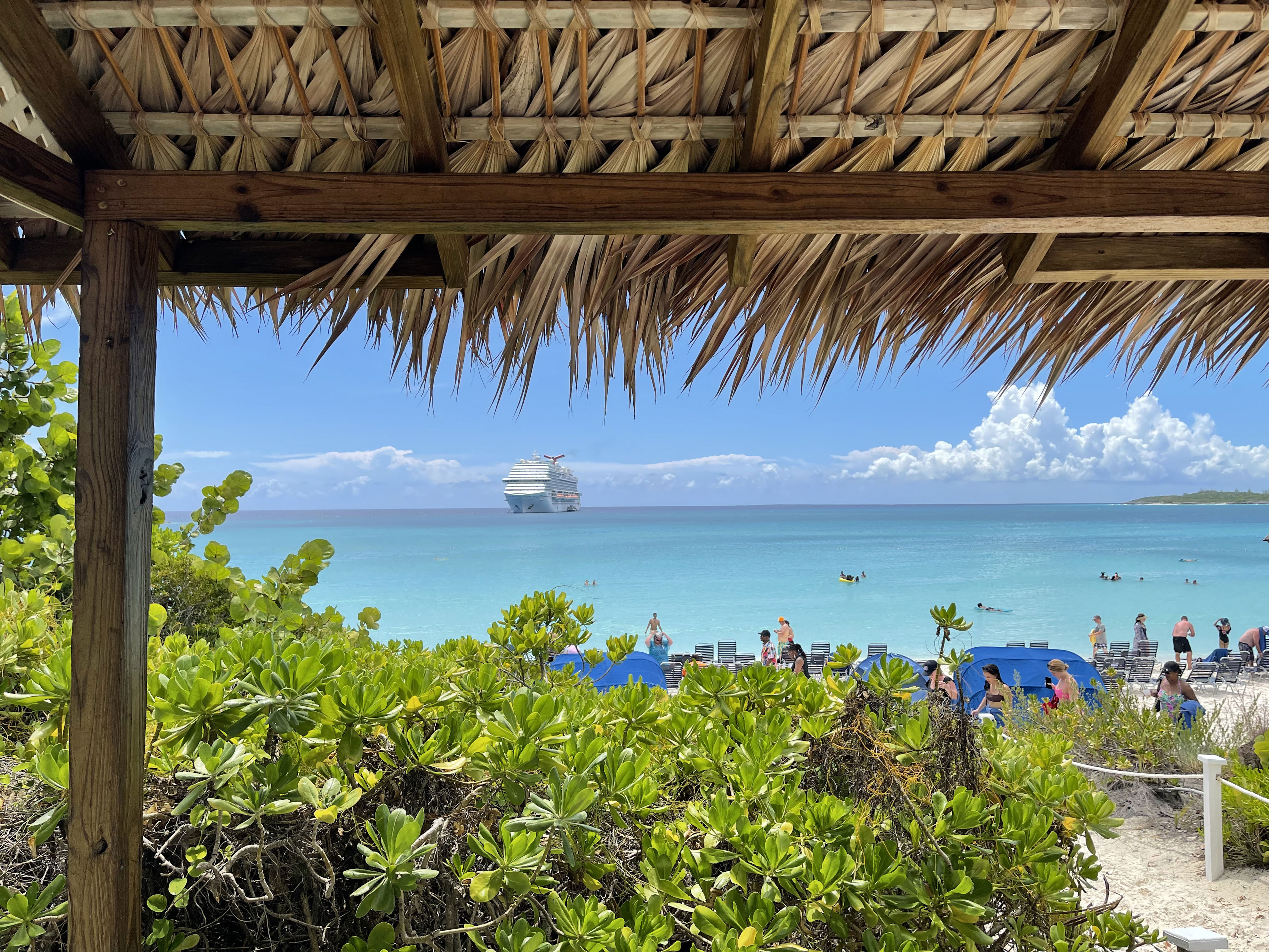Carnival ship anchored in the distance at half moon cay Bahamas