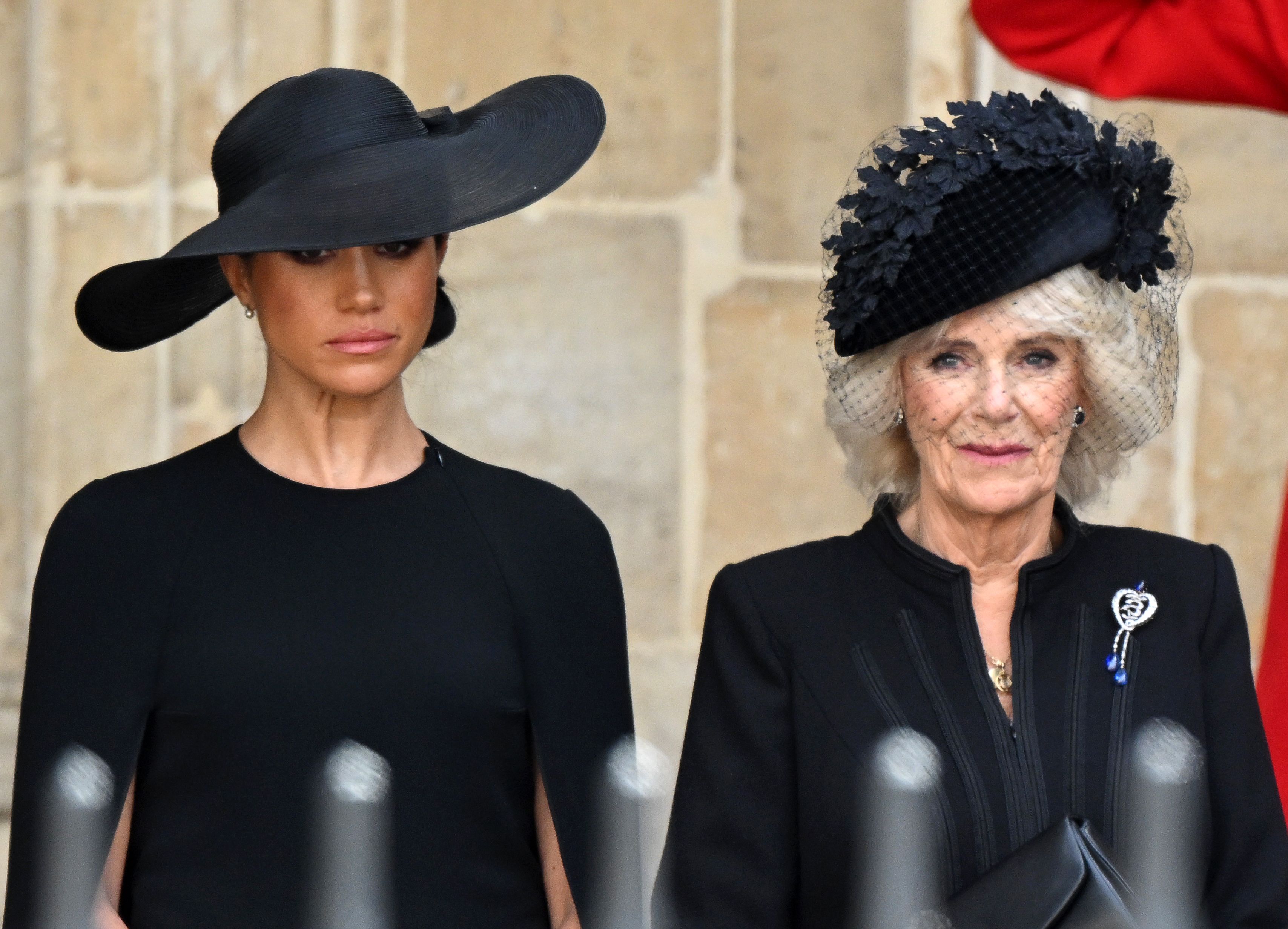 <p>Duchess Meghan and Camilla, Queen Consort watched as the coffin of Queen Elizabeth II left <a href="https://www.wonderwall.com/celebrity/royals/best-photos-from-queen-elizabeth-ii-funeral-king-charles-princes-william-prince-harry-george-charlotte-kate-meghan652347.gallery">her funeral</a> at London's Westminster Abbey on Sept. 19, 2022.</p>
