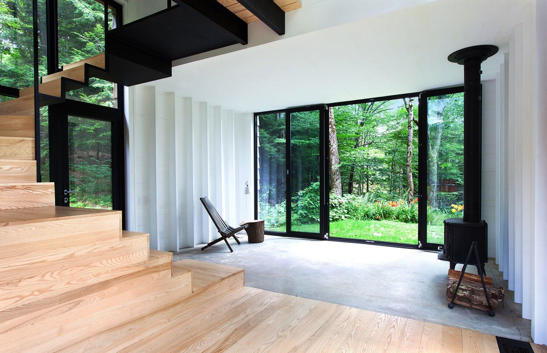 <p>In order to protect the surrounding landscape, the woodland was left entirely untouched during the build, allowing the trees to grow naturally around the property <span>–</span> resulting in ultimate seclusion! Once laid out over a single floor, the retreat now expands across three levels and spans 1,300 square feet. Light, bright and beautiful, the contemporary <a href="https://www.loveproperty.com/galleries/74547/the-cutest-chocolate-box-cottages-for-sale?page=1">cottage</a> is also ultra-chic, with floor-to-ceiling doors allowing the interior and exterior to softly merge together.</p>