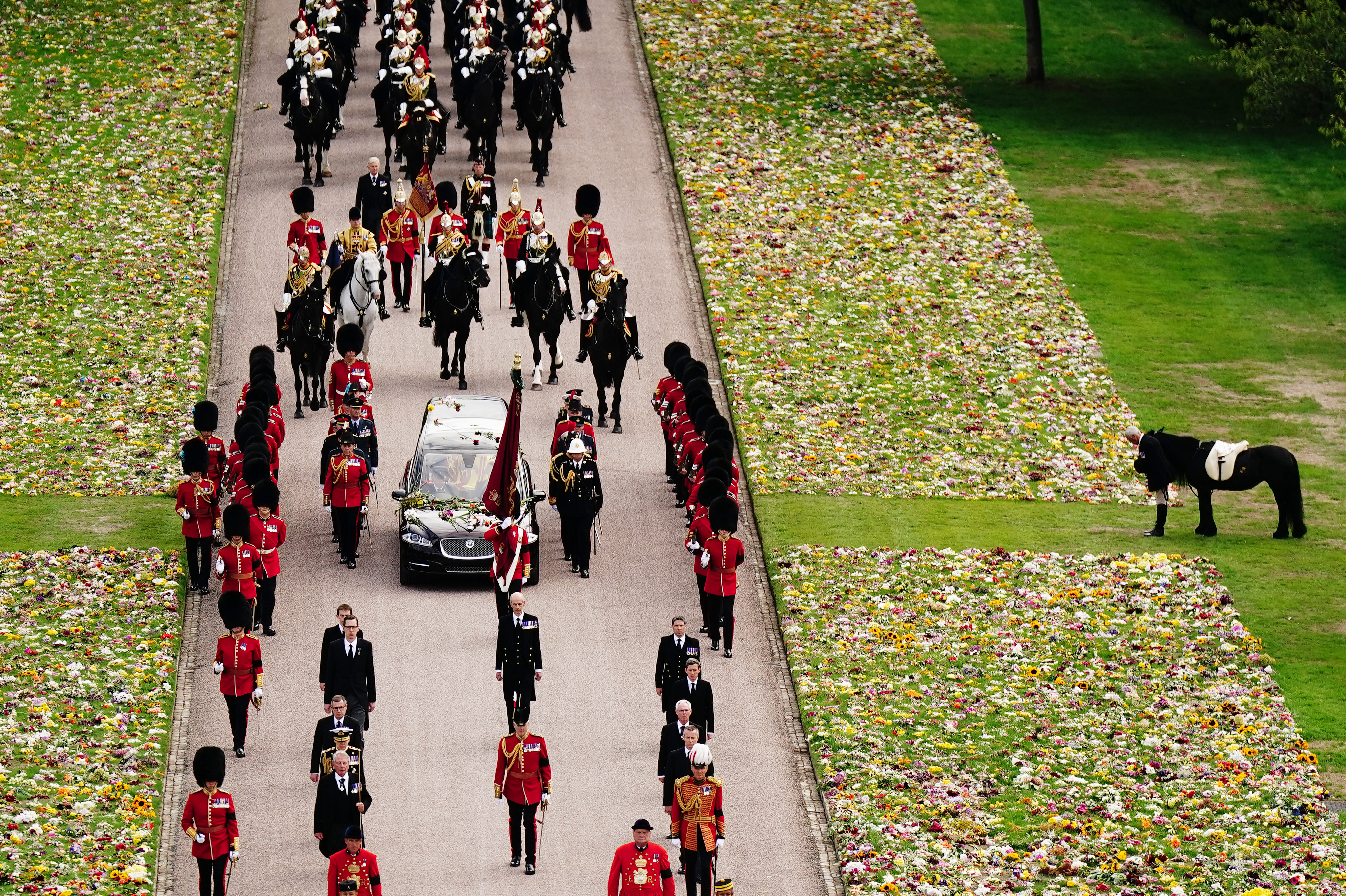 <p>Surrounded by thousands of flowers left by mourners, Emma -- the fell pony Queen Elizabeth II loved to ride around the grounds of her estate in Windsor, England -- stood riderless, watching as the monarch's coffin passed by and returned to Windsor Castle for the final time for <a href="https://www.wonderwall.com/celebrity/royals/best-photos-from-queen-elizabeth-ii-funeral-king-charles-princes-william-prince-harry-george-charlotte-kate-meghan652347.gallery">her interment at St. George's Chapel</a> on Sept. 19, 2022. </p>