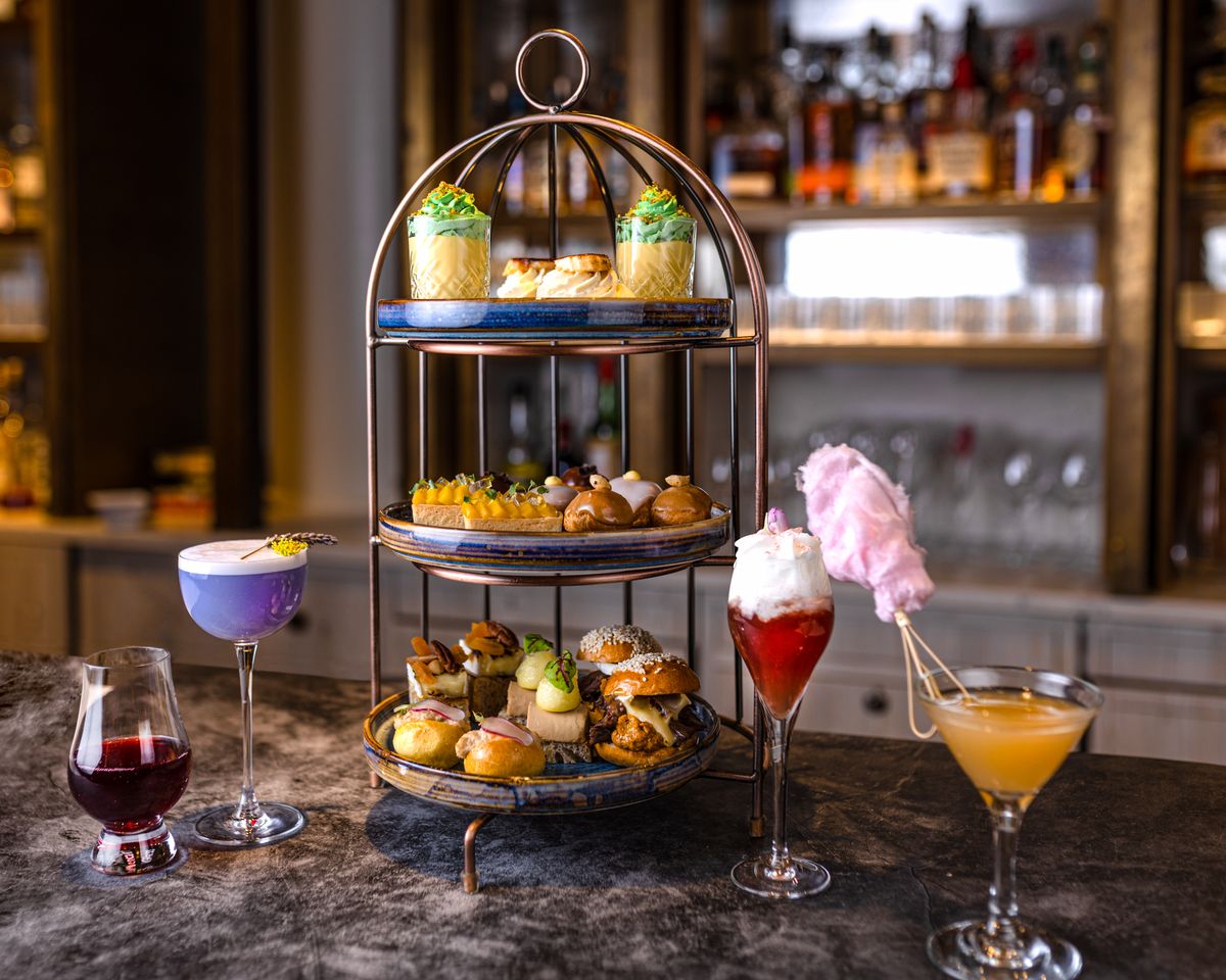 <p><strong>The bar: </strong></p><p>Stepping into <a href="https://rockwellcocktailbar.co.uk/">The Rockwell</a> feels like you’ve stepped into <em>Alice and Wonderland</em>, so inviting are the luscious green fauna that lines the bar’s ceiling and plush red velvet seating. In addition to the aforementioned Tipple Tea, The Rockwell’s cocktail menu is a celebration of all things luxury, pleasure and party. </p>