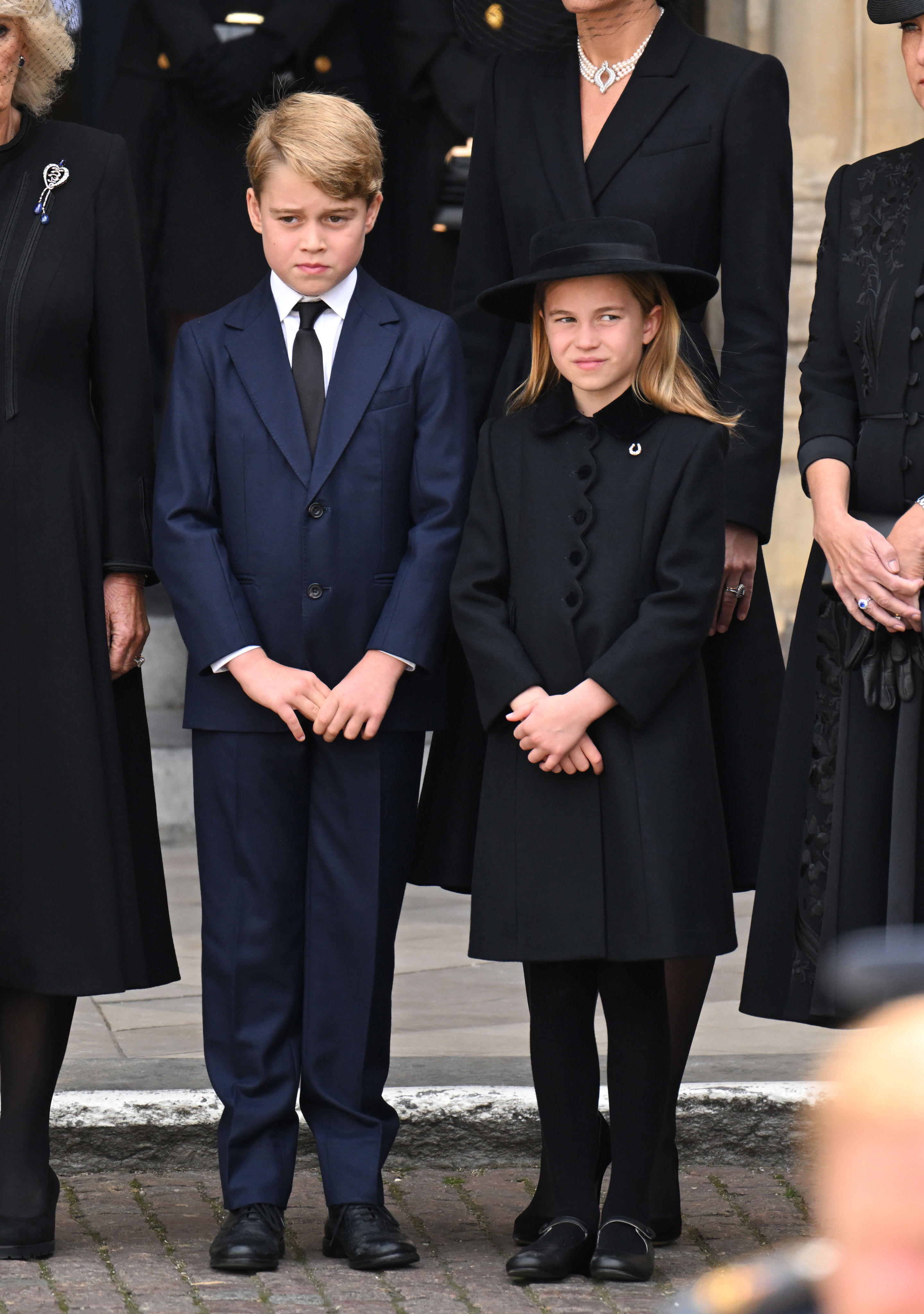 <p>Prince George of Wales and Princess Charlotte of Wales stood in front of Westminster Abbey in London during <a href="https://www.wonderwall.com/celebrity/royals/best-photos-from-queen-elizabeth-ii-funeral-king-charles-princes-william-prince-harry-george-charlotte-kate-meghan652347.gallery">the state funeral </a>of great-grandmother Queen Elizabeth II on Sept. 19, 2022.</p>