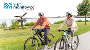 Visit Manitowoc&#x2019;s new logo, as featured on a publicity item of people biking on Mariners Trail.