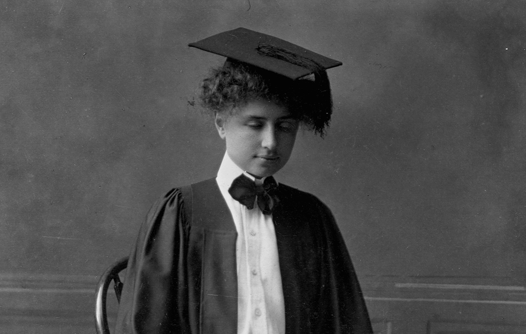 <p>In 1900, Keller was accepted into the renown Radcliff College in Cambridge. Anne was accepted as well so she could attend her classes and help her along the way. Before entering school, she had learned to read peoples' lips using her fingers, as well as braille, typing, and finger spelling. Keller had also learned to speak although not as well as she would have liked.</p> <p>By her junior year, she had written her autobiography, <i>The Story of My Life. </i>By 1904, not only had she written a book, but she also graduated with a Bachelor of Arts, making her the first blind and deaf student to ever attain a college degree. </p>