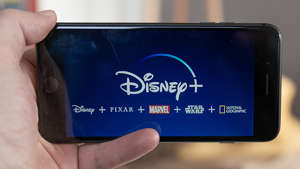 Disney+ startscreen on mobile phone. Disney+ online video, content streaming subscription service. iStock