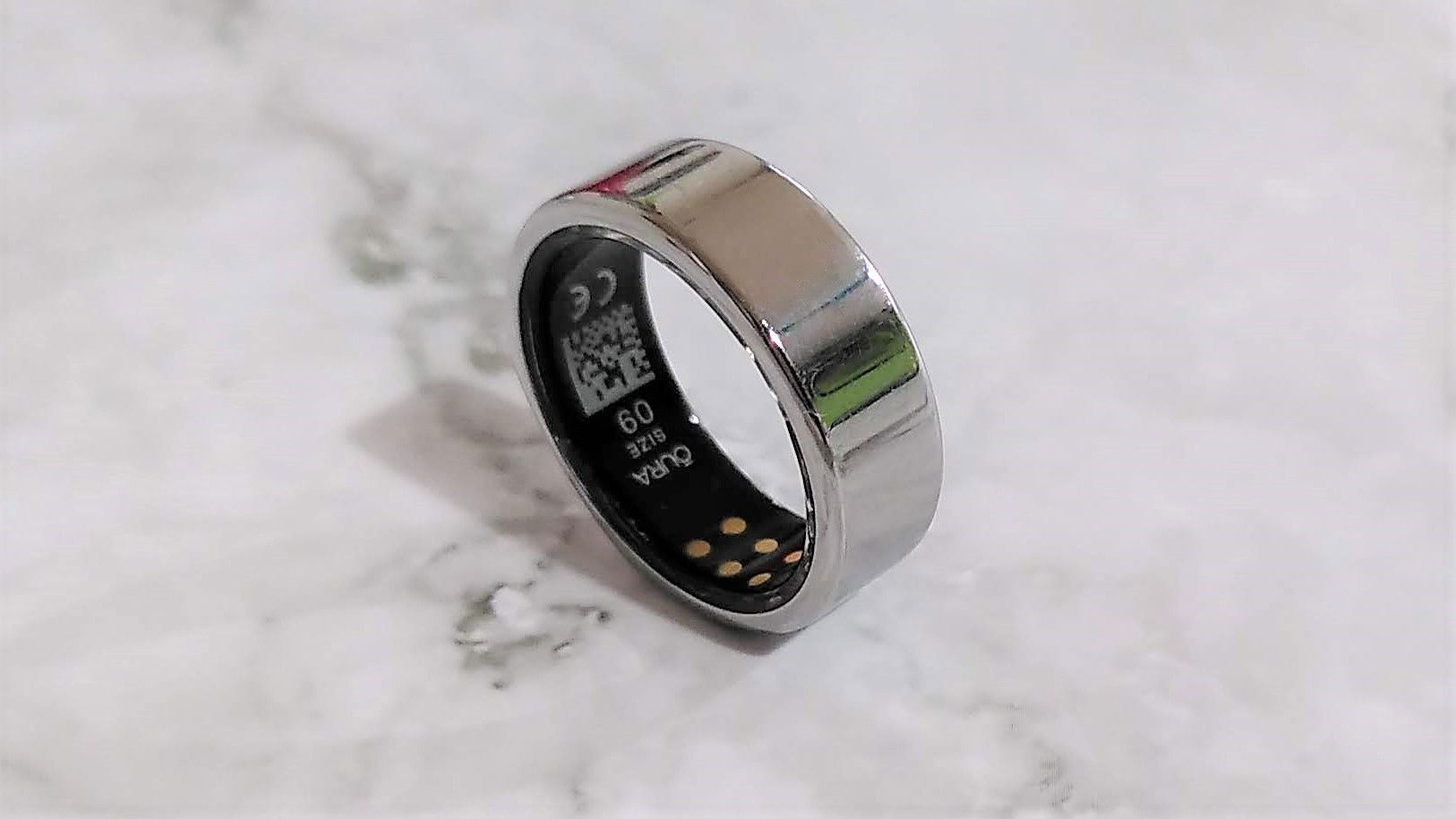  The image shows a silver Samsung Galaxy Ring device which is compatible with Galaxy smartphones and select Android devices.
