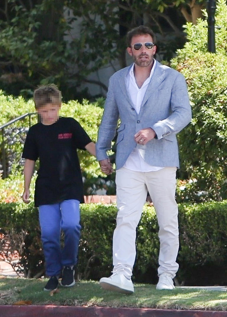 Ben Affleck looks sharp in white pants and a white shirt paired with a light gray blazer as he is seen running a few errands with his son Samuel in Santa Monica. Sam wore a black T-shirt and jeans.