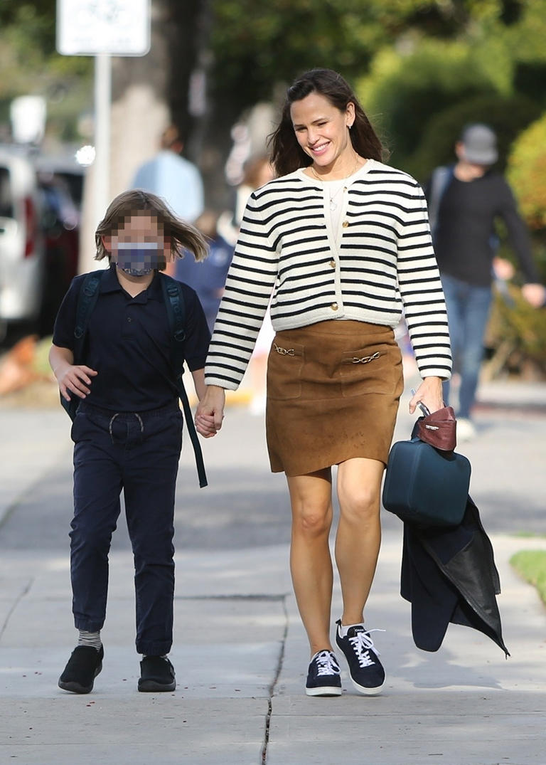 Jennifer Garner held her son Samuel’s hand as she picked him up from school in January 2022. Samuel rocked a navy blue polo, while walking with his mom.