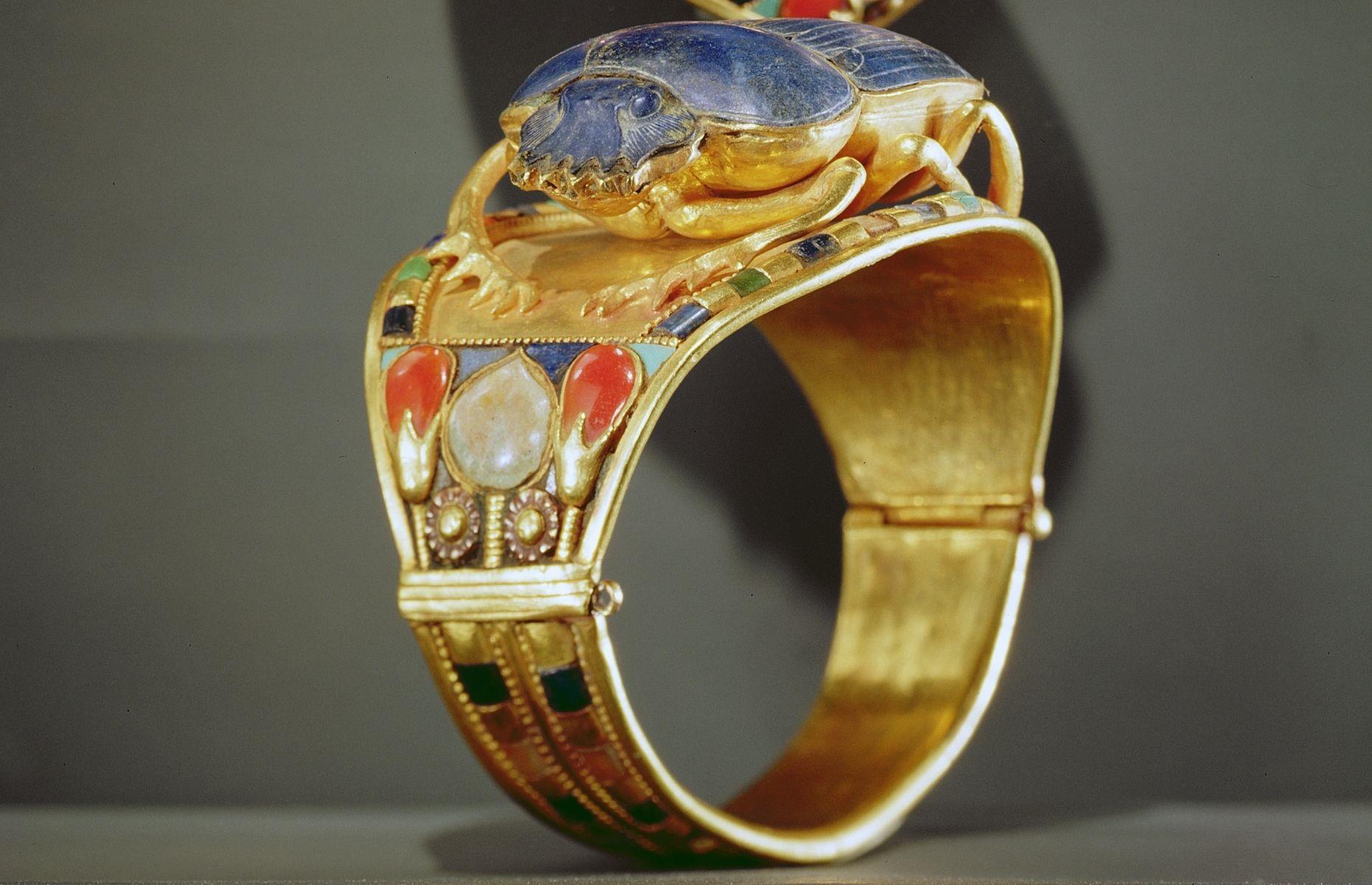 <p>Ornate jewellery was commonly stored inside Egyptian pyramids, either as divine offerings or to accompany the deceased into the afterlife. This spectacular scarab bracelet is just one of the items found inside Tutankhamun's tomb. Formed from gold and lapis lazuli, the intricate trinket is a gorgeous example of ancient craftsmanship. Regardless of <a href="https://www.gemrockauctions.com/learn/did-you-know/ancient-egyptian-jewellery#:~:text=The%20ornaments%20included%20heart%20scarabs,,%20animal%20teeth,%20and%20shells.">gender or status</a>, the Egyptians loved jewellery, and over the centuries endless precious charms and ornaments have been discovered. </p>