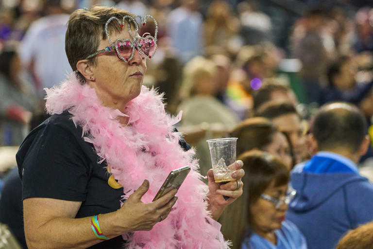 An Elton John fan looks out into the crowd before Elton John takes the stage for his "Farewell Yellow Brick Road The Final Tour" on Friday, Nov. 11, 2022, at Chase Field in Phoenix.