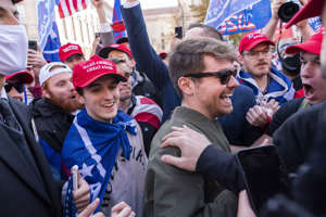 Nick Fuentes right-wing podcaster, center right in sunglasses, greets supporters before speaking at a pro-Trump march, Nov. 14, 2020, in Washington. (AP Photo/Jacquelyn Martin, File)