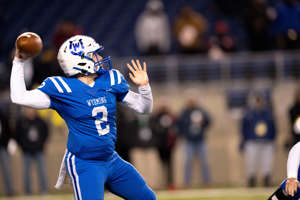 Wyoming Cowboys quarterback Quaid Hauer (2) throws a passin the OHSAA DIV state championship game between at Tom Benson Hall of Fame Stadium in Canton, Dec. 3.