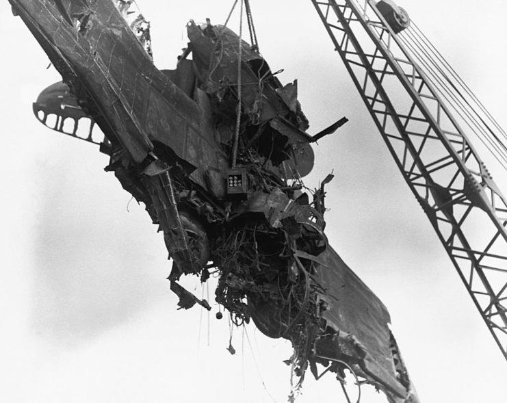 <p>Damaged aircraft being lifted into the sky following the attack on Pearl Harbor. This was one of the many aircraft stationed at the naval base when the Japanese launched their assault.</p>