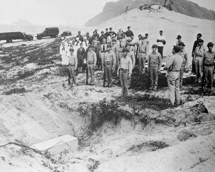 <p>US military personnel standing before the grave of a Japanese pilot who was killed during the attack. As with American servicemen who lost their lives on Ford Island, the enemy combatant was buried on the beach at Pearl Harbor.</p>
