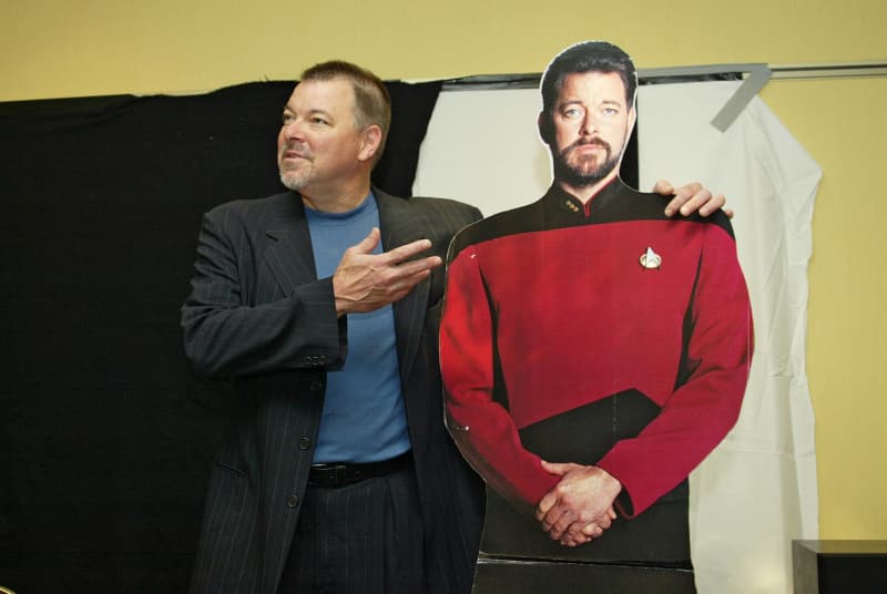 <p>"William Thomas Riker" is probably most known for his longest campaign as an officer under "Captain Jean Luc-Picard" aboard the 'USS Enterprise-D'. Later on in the series, he accepts the promotion as Captain aboard the 'USS Titan'. "Riker" is romantically linked to "Deanna Troi," the starship's counselor.</p>