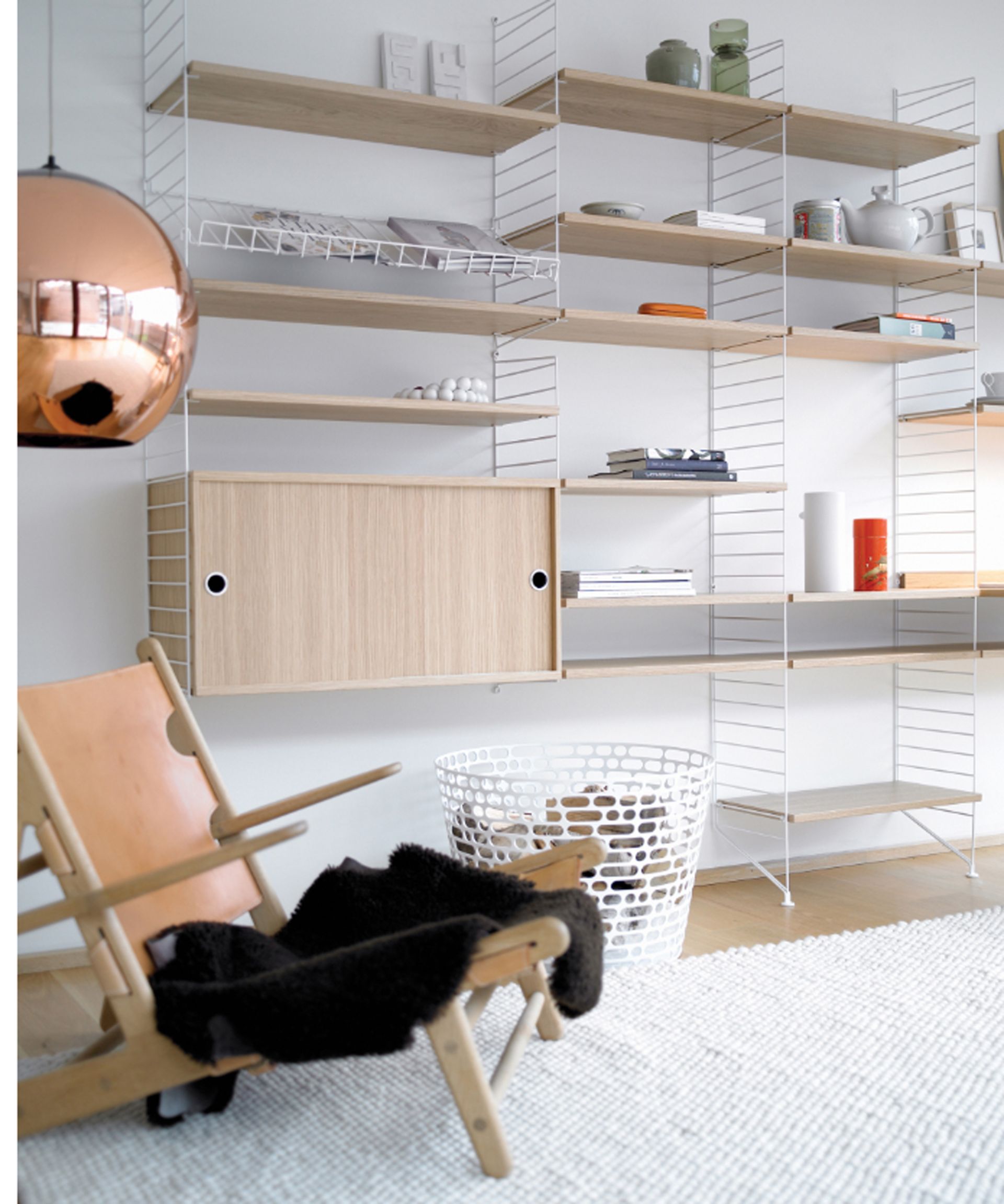 <p>                     When your floor space is at a premium but you need to add storage to your apartment living room, open shelving is the way to go.                   </p>                                      <p>                     'We suggest you use all the available space you have, including your walls. You can use shelves, but also use your walls to store your dining chairs for easy access and to not clutter your floor space,' explain Henderson and Bradley.                    </p>                                      <p>                     Peter Erlandsson, Co-Owner of String Furniture agrees, 'In a small room, it’s great to be able to change the design once in a while. Sleek wall shelving provides you with plenty of flexibility both practically and aesthetically, meaning you can achieve a completely new look whenever you like. There is an age old doctrine of using light colors on walls to make your home look bigger. This is true, and your shelves need not detract from this.' You can invest in this String System in ash at Utility Design.                    </p>                                      <p>                     Opt for something slimline in the same color as the wall it's going to sit on, so you can maximize the storage space and so your shelving idea doesn't dominate the room too much.                   </p>