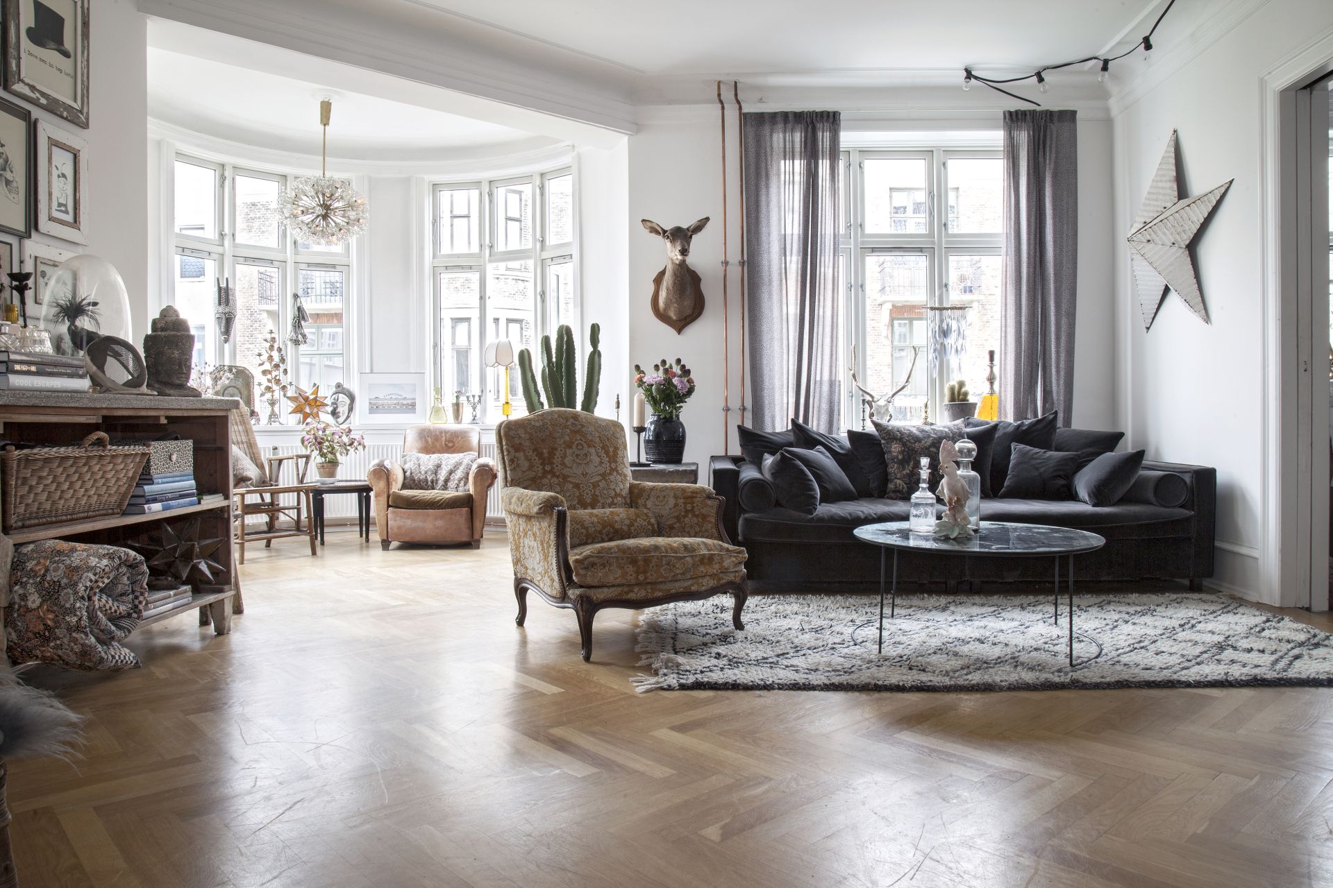 <p>                     We love the whole vibe of this Copenhagen apartment. By mixing so many different styles and textures this room is so unique and full of personality. Recreate that in your living room by picking out furniture that means something to you (even if you think it won't go, that's part of the look).                    </p>                                      <p>                     Start collecting objects and decor that feel personal to your style and layer them up with new pieces to create a very eclectic cozy space, that still has a stylish, contemporary feel.                    </p>
