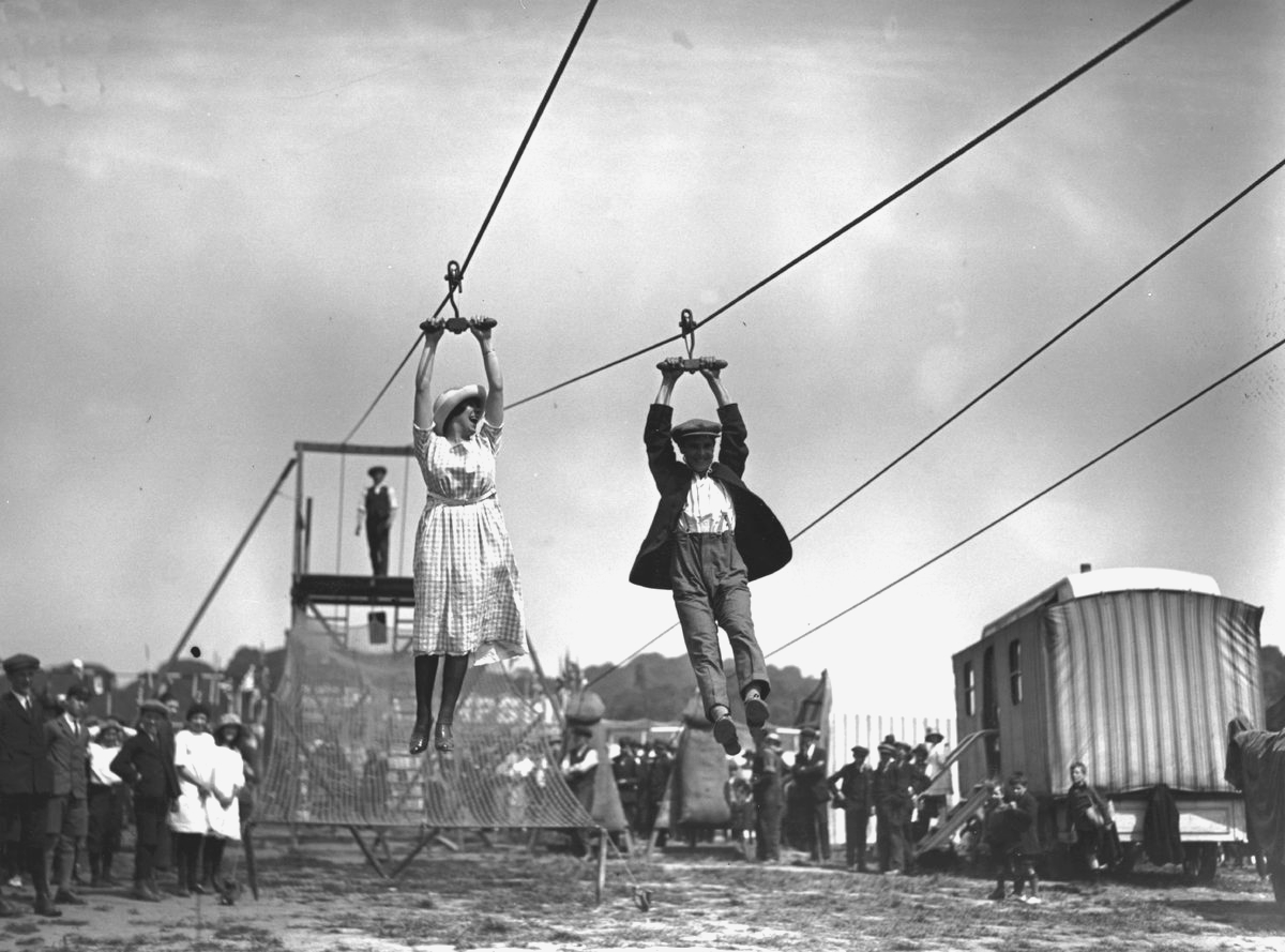 <p>Back in the '20s, young lovers dated online or rather, on-a-line. This young couple appears to be having a blast on a pulley ride at a fair in London's Hampstead Heath in 1922. This early form of recreational zip-lining looks dangerous considering the riders don't have on any protective gear. They seem to be pretty close to the ground though, and hopefully, they didn't have to ride that far out. </p> <p>Aerial cables have been used as transport methods for more than 2,000 years, but it wasn't until 1739 when steeplejack and ropeslider Robert Cadman first used one as entertainment. Unfortunately, he didn't survive.</p>