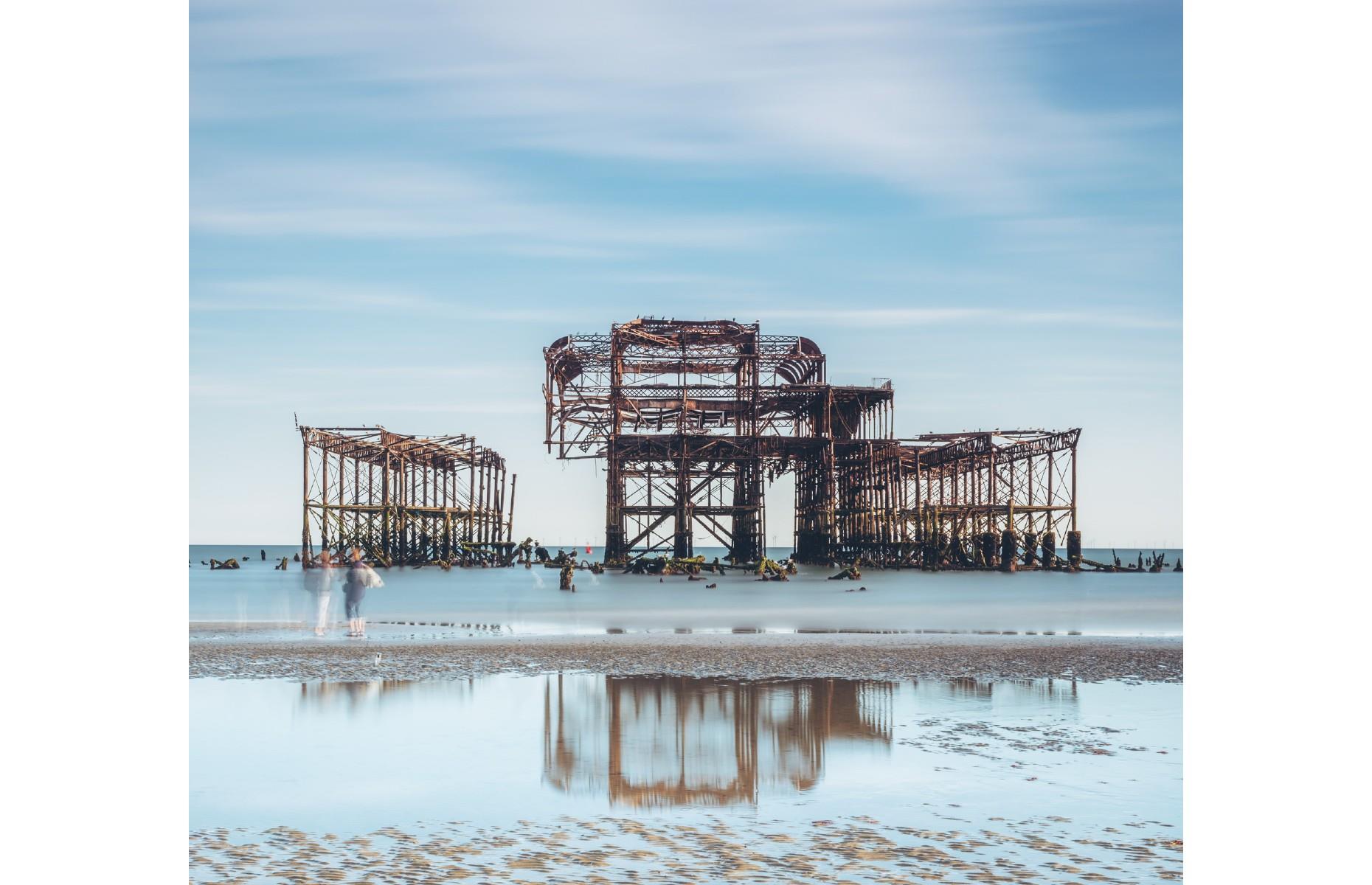 <p>While tourists flock to <a href="https://www.loveexploring.com/news/138874/best-things-to-do-in-brighton">Brighton</a>'s newer Palace Pier for fairground rides and candyfloss, photographers are generally more taken in by the skeletal remains of West Pier. Opened in 1866 but destroyed by storms and fires, the eerie remains of the landmark look especially poignant in this impressive shot by Darren Smith, with two ghostly figures making an appearance on the shore. </p>