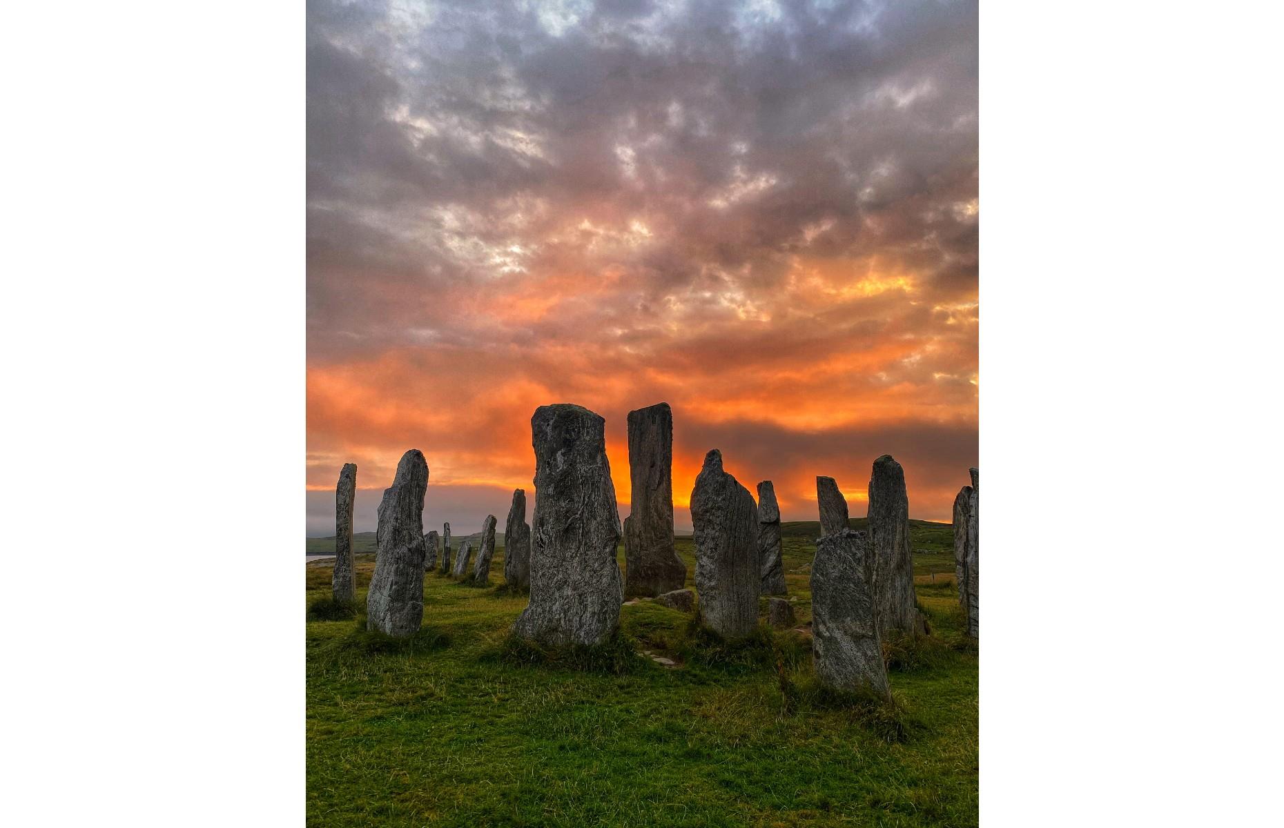 <p>Dating back around 5,000 years, the Calanais Standing Stones are one of Scotland's best-preserved Neolithic monuments and actually predate England's Stonehenge. Derek Mccrimmon has beautifully captured the cross-shaped stone circle in this magical image, in which the ancient monument appears ignited by fiery-hued clouds. </p>  <p><a href="https://www.loveexploring.com/galleries/127724/30-amazing-sights-older-than-stonehenge?page=1"><strong>Discover the amazing sights that are older than Stonehenge</strong></a></p>