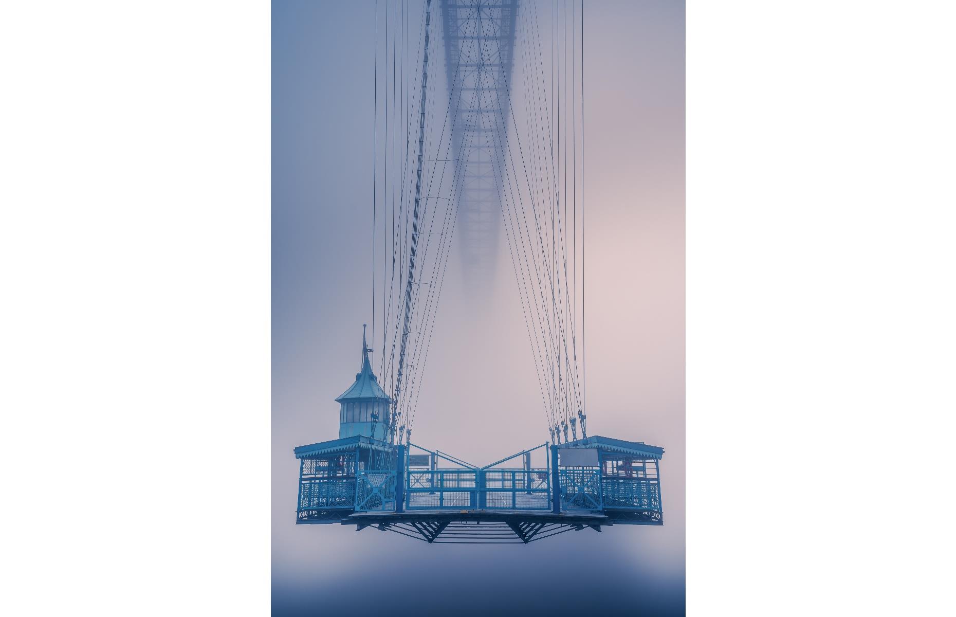 <p>One of just six operational transporter bridges left in the world, Newport Transporter Bridge is essentially a suspended ferry, with a boom that allows ships to pass underneath, and a railway track on which a moving carriage operates. The landmark, which first opened in 1906, is shown in a new light in this stunning image by Itay Kaplan, which was shot during early-morning fog just after sunrise. </p>  <p><a href="https://www.facebook.com/loveexploringUK?utm_source=msn&utm_medium=social&utm_campaign=front"><strong>Love this? Follow us on Facebook for more travel inspiration</strong></a></p>