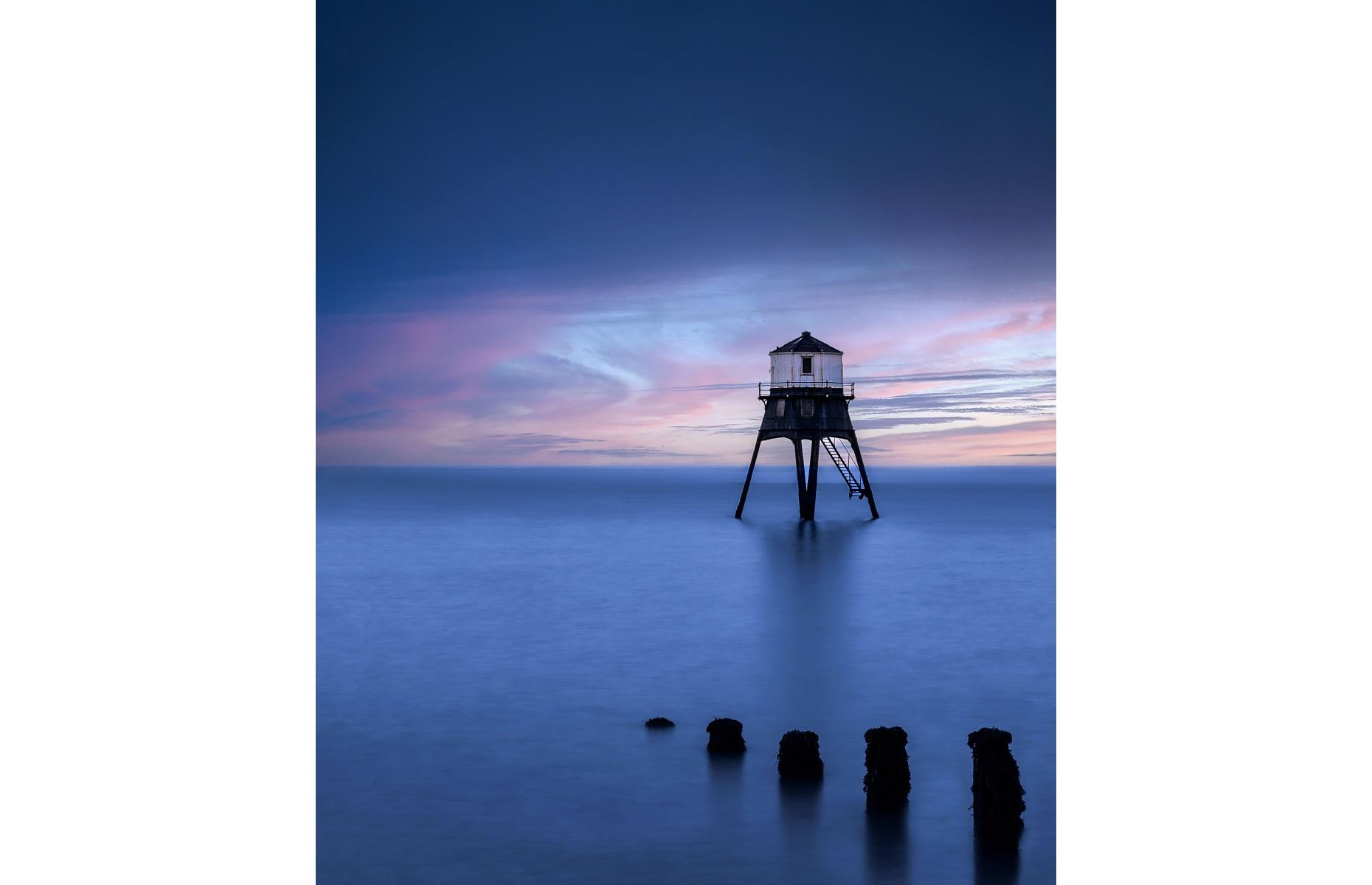 There are two beacons which grace this stretch of the Essex coastline: the High and Low lighthouse, both of which were built in 1863 to guide vessels around Languard Point. In this serene image, photographer Mark Roche highlights their architectural beauty, with the beacon casting a stark silhouette against the blues, indigos and violets of sunset.