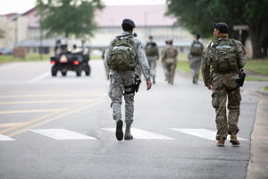 Service members walk at Maxwell Air Force Base. Maxwell Air Force Base