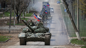 A convoy of pro-Russian troops moves along a road in Mariupol, Ukraine, on Thursday, April 21, 2022. REUTERS/Chingis Kondarov
